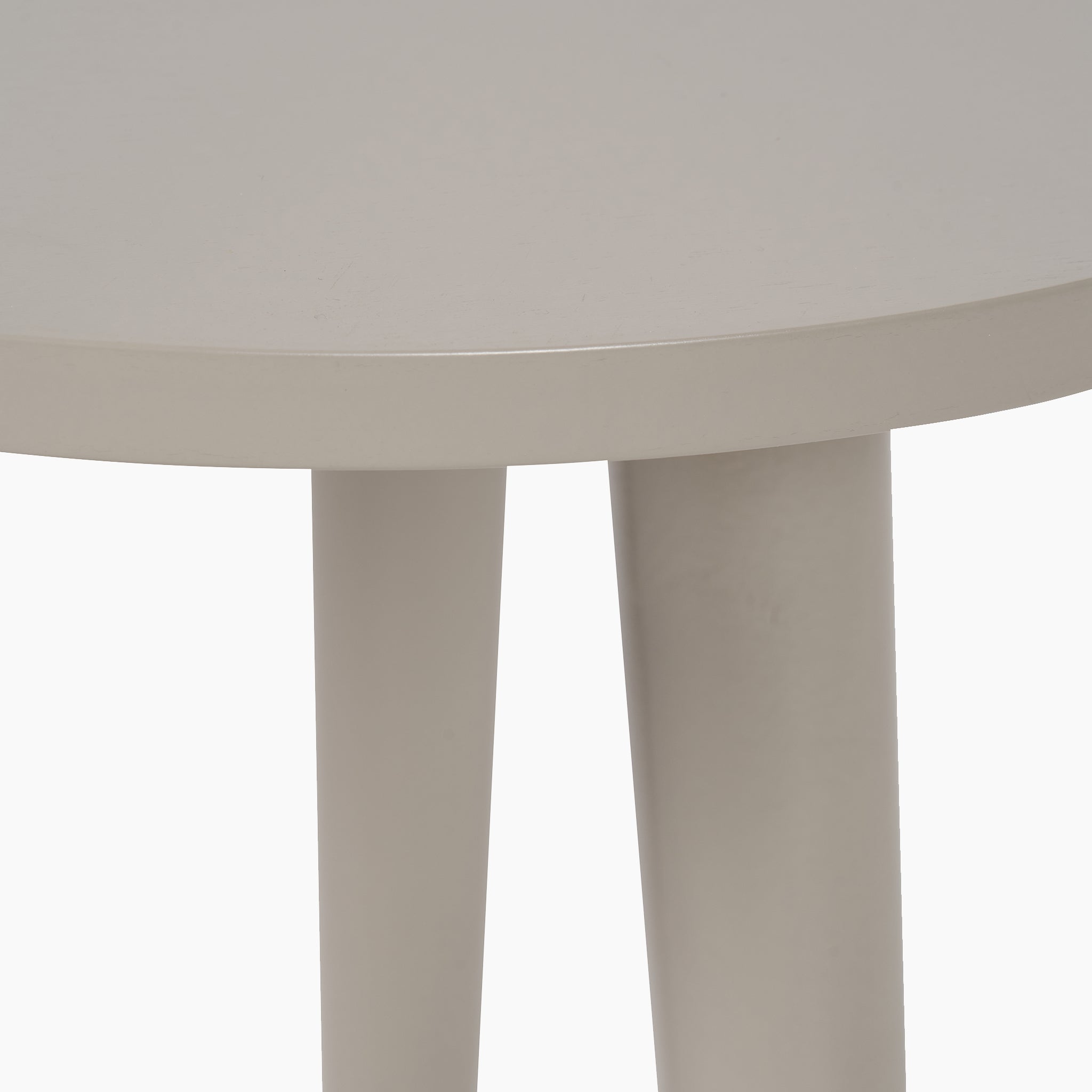 Close-up of the Pacific Lifestyle Devonshire Putty Pine Wood Side Table, featuring a round light gray top, three cylindrical legs, and a compact mid-century-inspired silhouette against a white background.