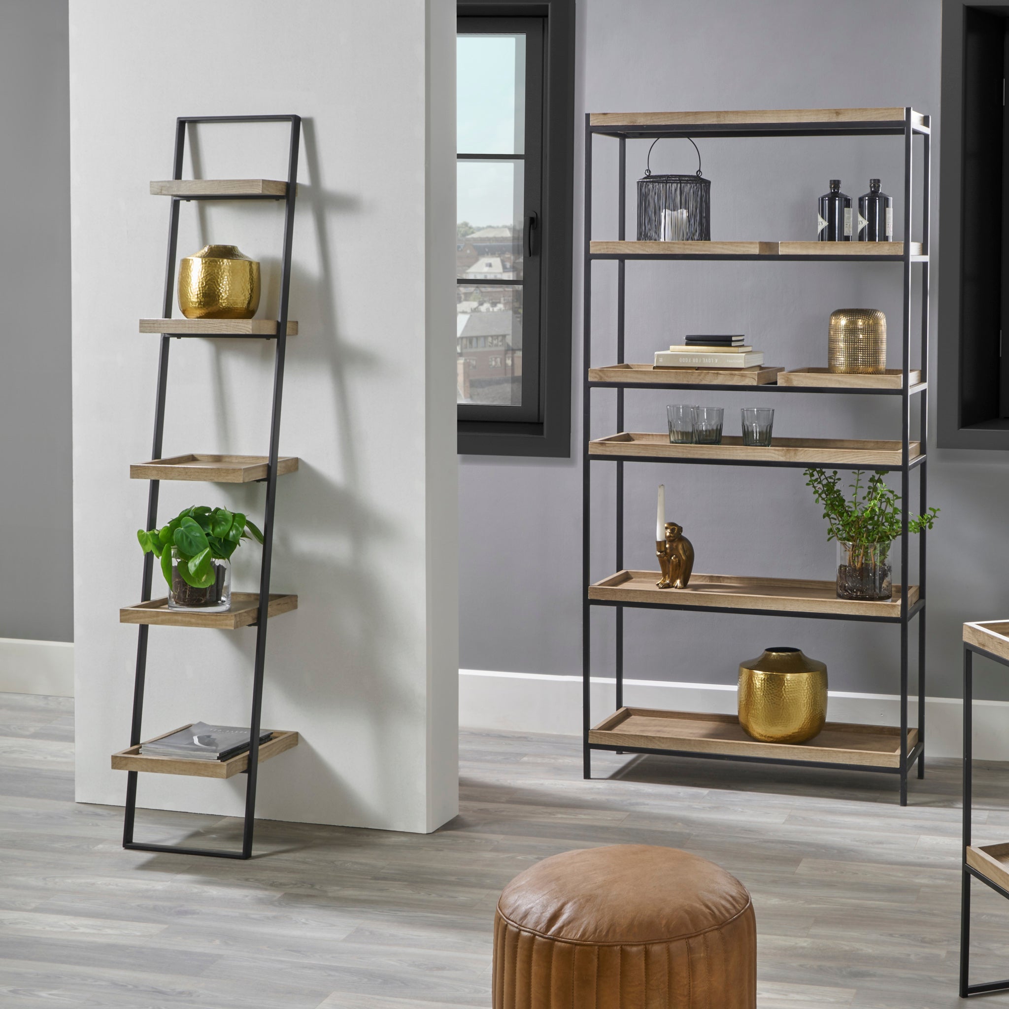 Modern living room with a Scandinavian aesthetic featuring the Pacific Lifestyle Gallery Natural Wood Veneer and Black Metal 5 Shelf Ladder Unit, adorned with plants, gold vases, and ornaments for a cozy yet stylish ambiance.