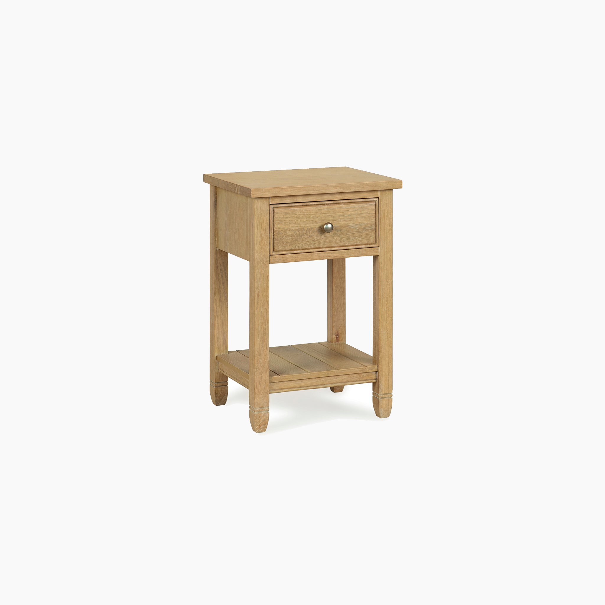 Amberley Bedside Table in Light Oak with one drawer, round metal knob, and lower shelf, shown against a white background.