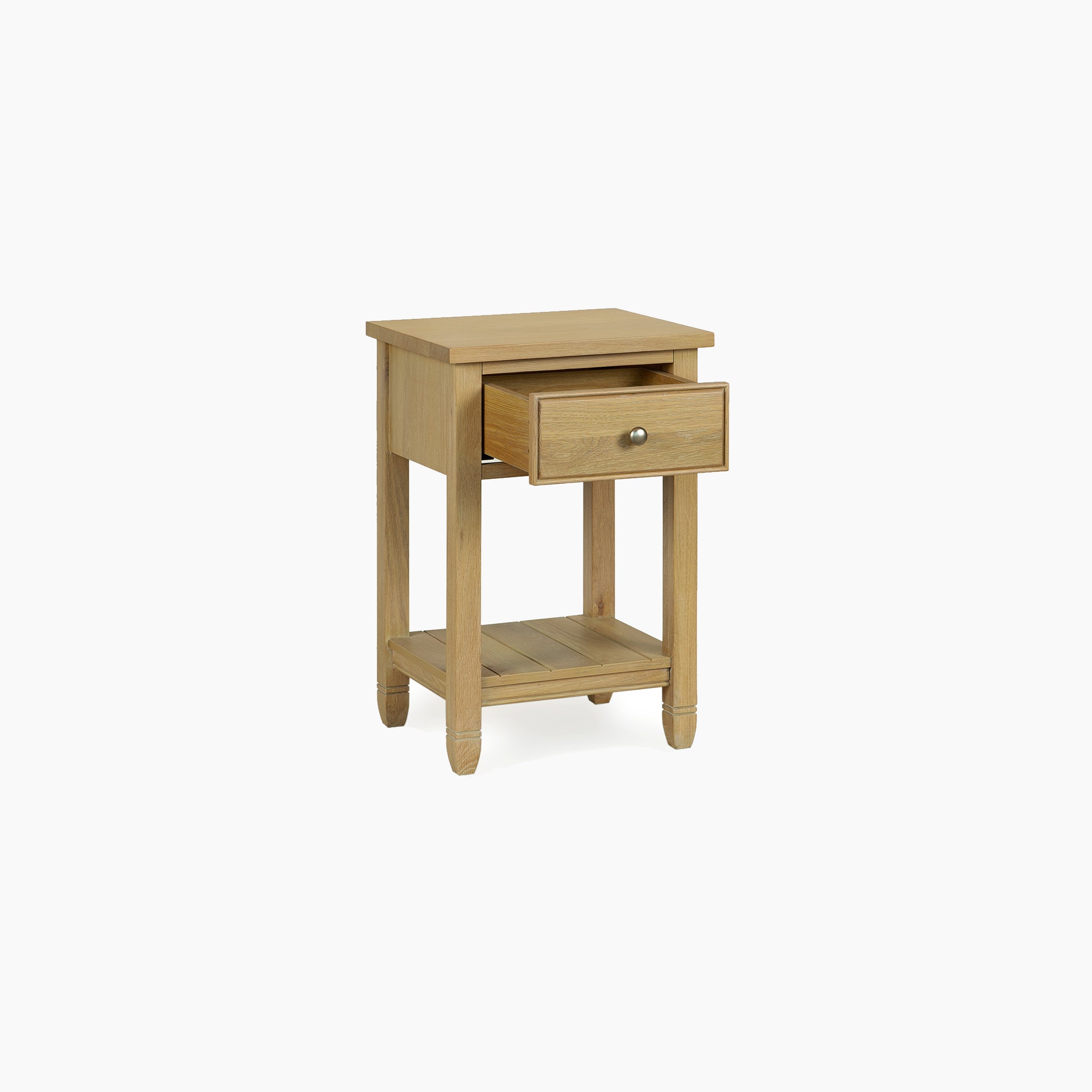 The Amberley Bedside Table in Light Oak has one open drawer and a lower shelf, displayed on a plain white background.