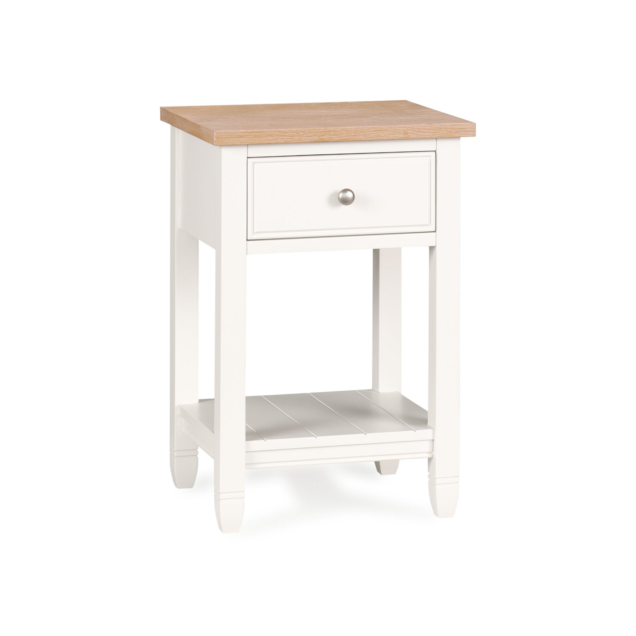 The Amberley Bedside Table in Warm White features a compact design with a light wood top, single drawer, lower shelf, and four legs—an ideal modern country bedside table for any room.