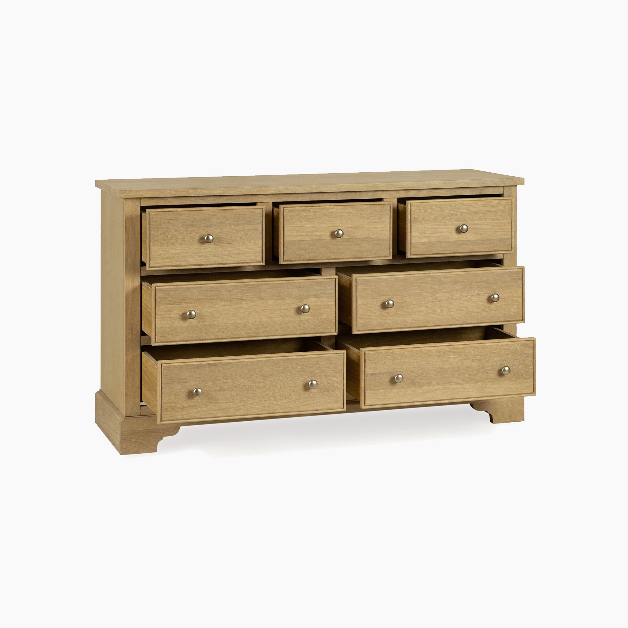 The Amberley 3 Over 4 Chest of Drawers in Light Oak features seven spacious drawers, ideal for versatile bedroom storage and shown against a white background.