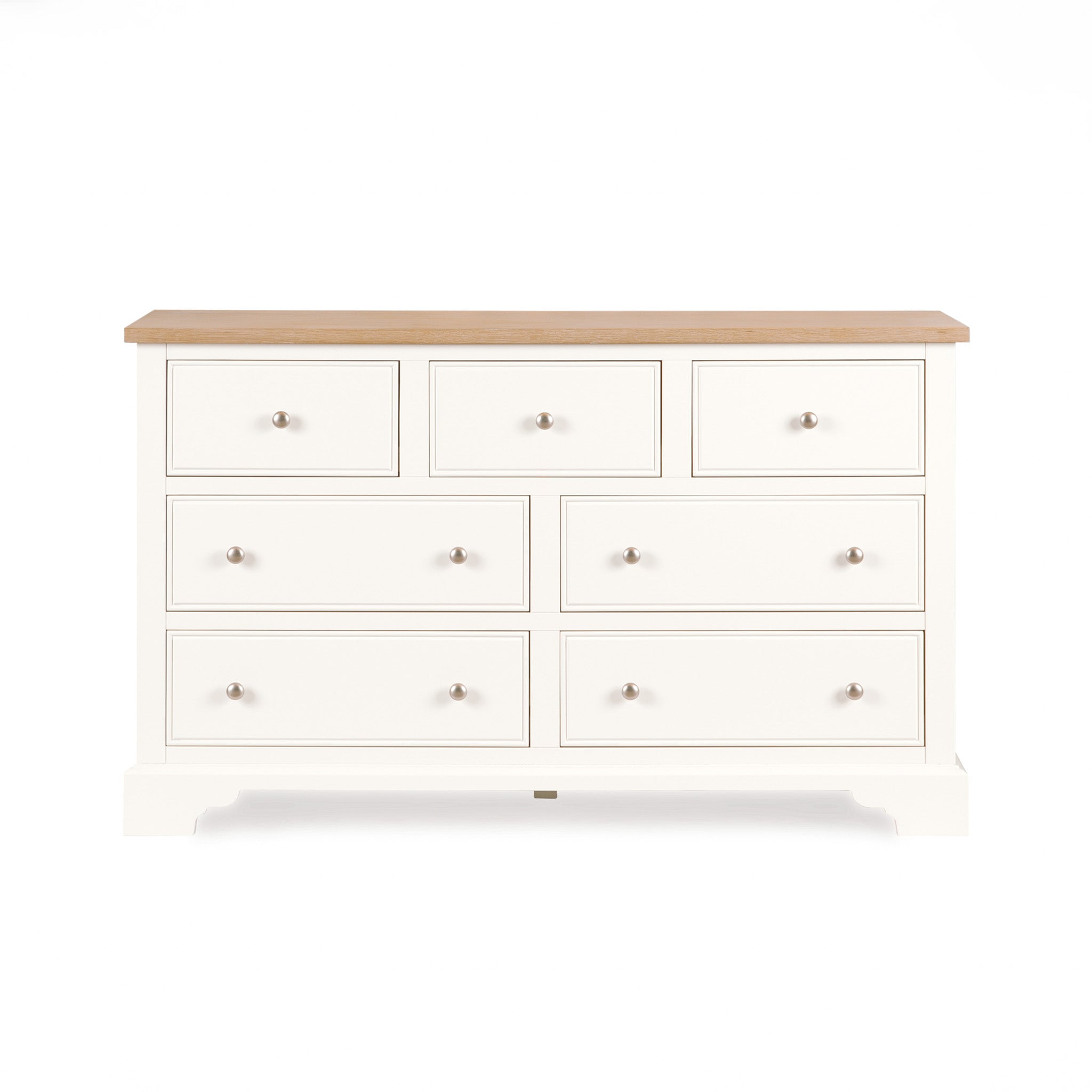 Amberley 3 Over 4 Chest of Drawers in Warm White, featuring seven spacious drawers and a light oak top, set against a plain white background.