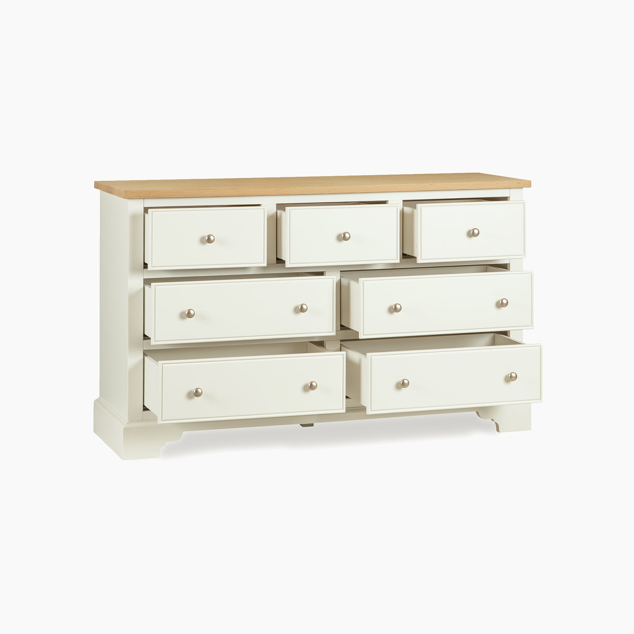 The Amberley 3 Over 4 Chest of Drawers in Warm White features an oak top and seven spacious drawers, with three smaller drawers above four larger ones for versatile storage.