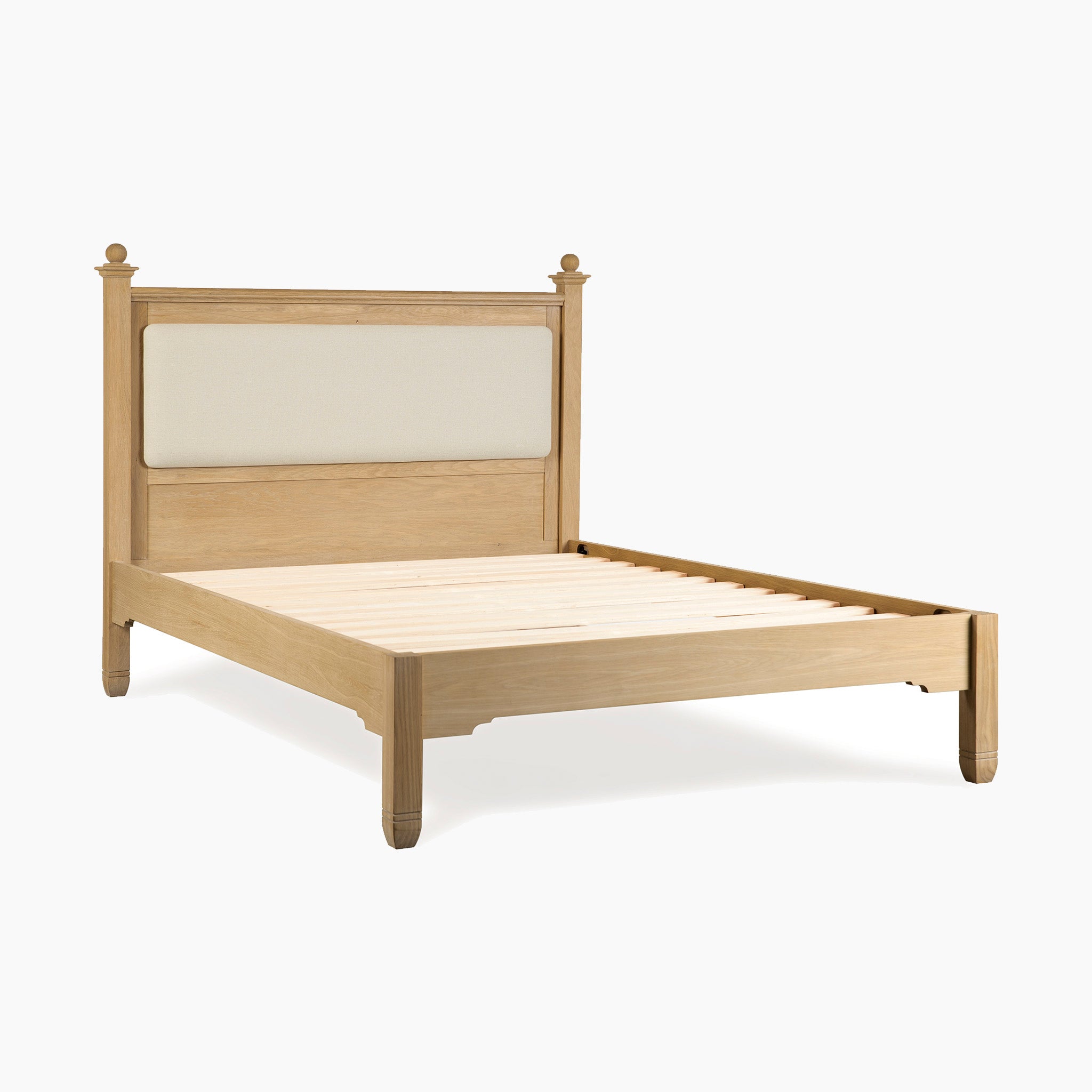 Amberley 4ft 6" Double Bed Frame in Light Oak features an upholstered headboard panel, ideal for adding country charm to your bedroom. Shown against a white background.