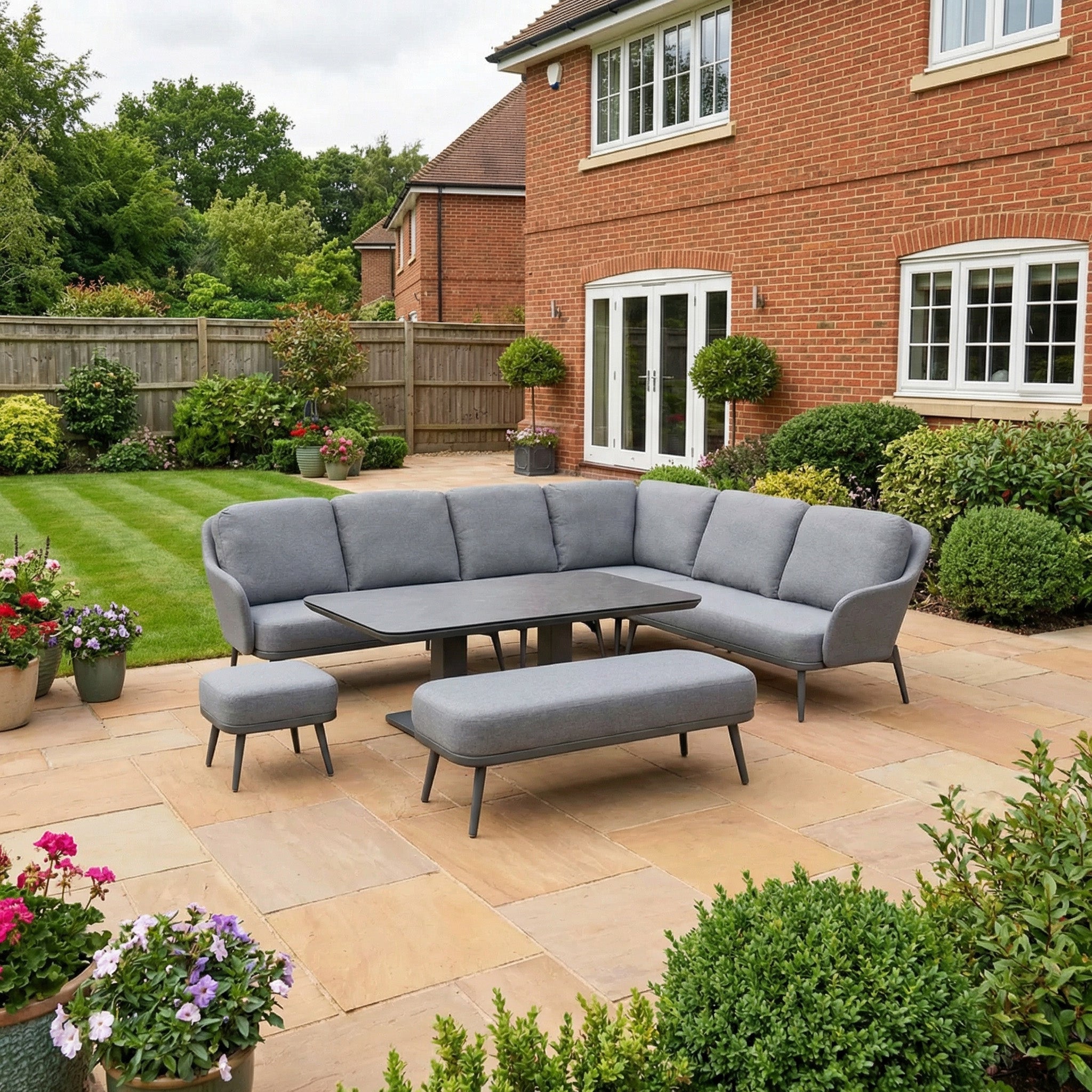 The Alva Corner Dining Set with Rising Table in Grey features a modern outdoor sectional, matching benches, and a versatile rising table—perfect for stylish garden dining on your patio.