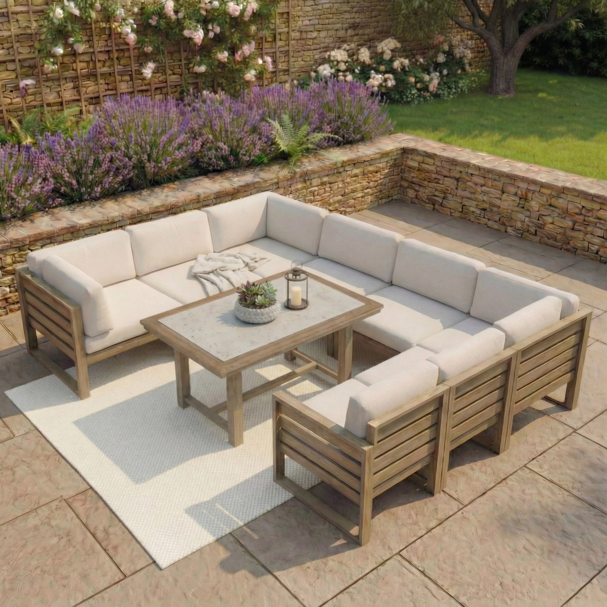 The Andora U Shape Corner Sofa Set with 2 in 1 Table in Weathered Brown creates a welcoming patio space, surrounded by lush plants and flowers.