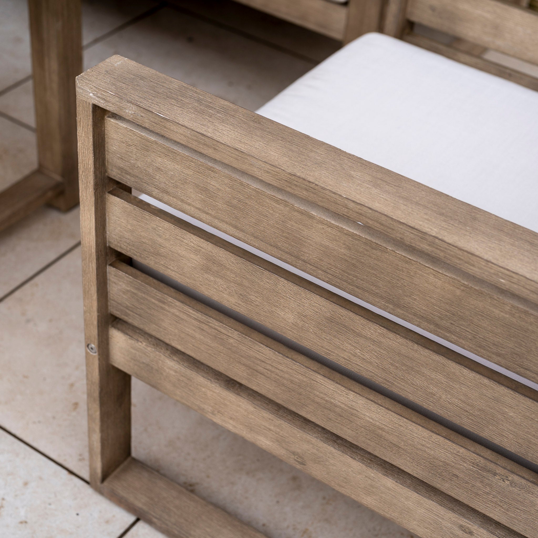 Close-up of the Andora Large Corner Sofa Set with 2 in 1 Table in Weathered Brown, featuring a white cushion on a tiled floor that highlights the set’s comfort and style for modern outdoor spaces.