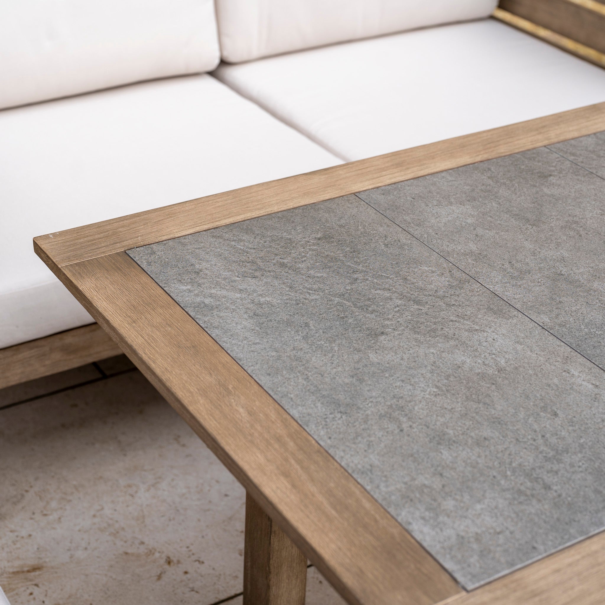 Close-up of the Andora Large Corner Sofa Set with 2 in 1 Table in Weathered Brown, featuring a gray stone top—ideal for creating stylish modular outdoor furniture arrangements.