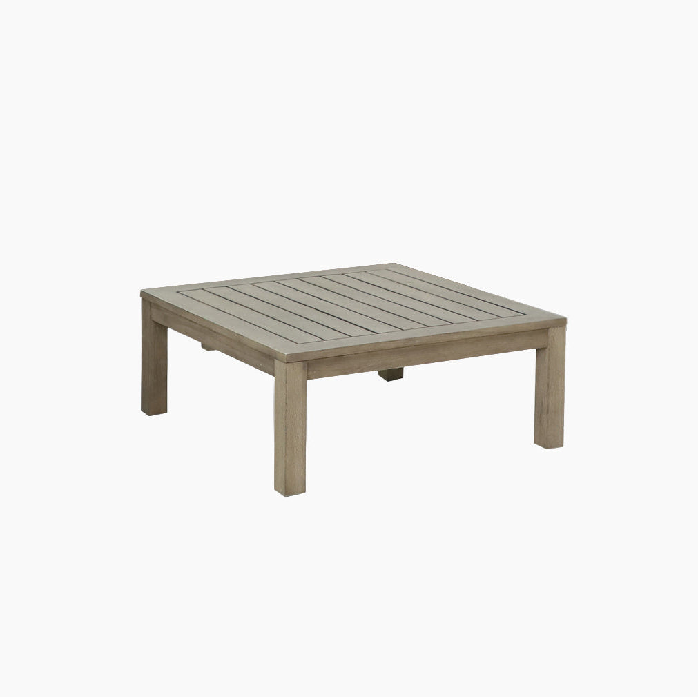 The Andora 3 Seat Sofa Set with Coffee Table/Footstool in Weathered Brown features a square wooden coffee table with a slatted top and sturdy legs, designed to complement modular garden furniture, shown on a plain white background.
