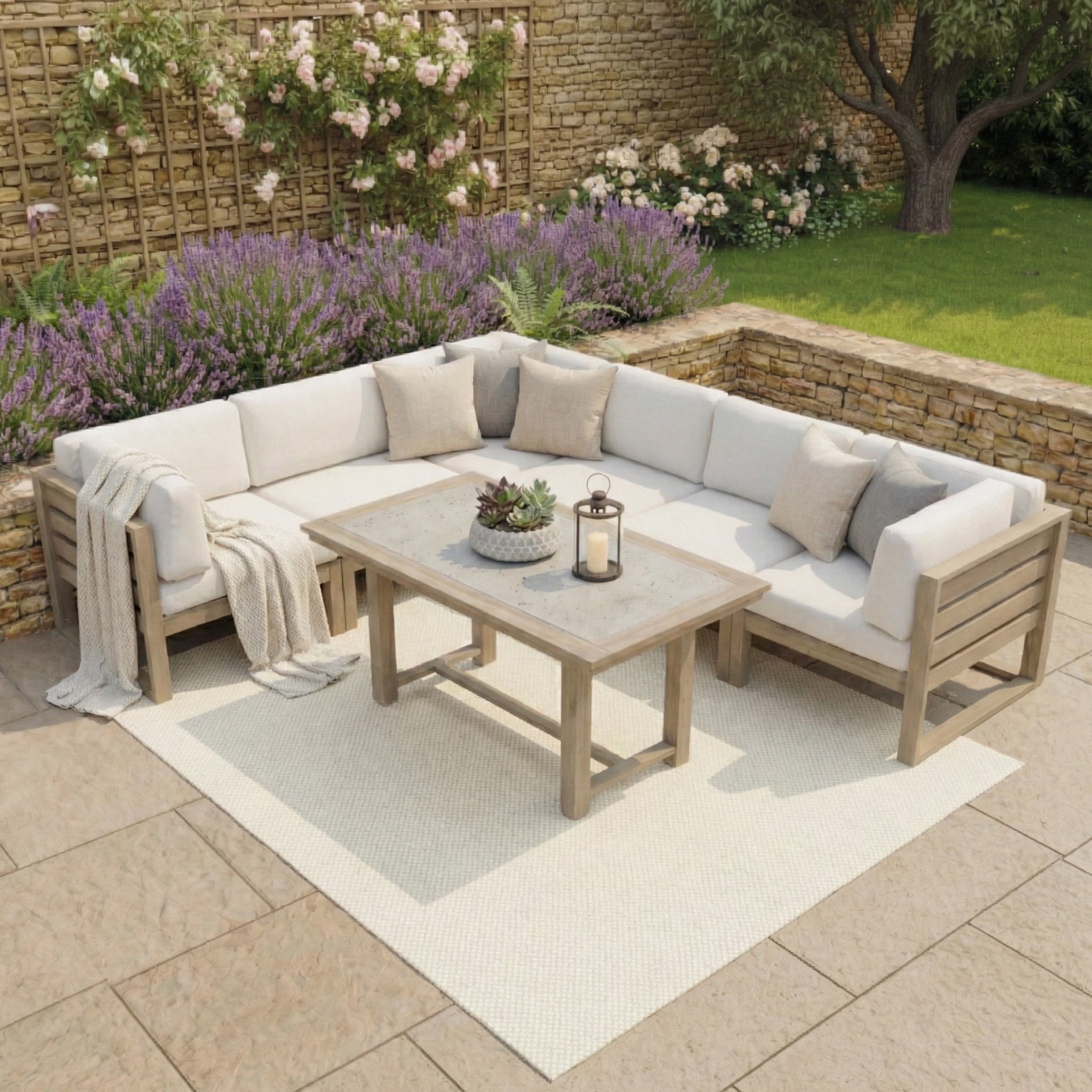 The Andora Large Corner Sofa Set with 2 in 1 Table in Weathered Brown sits on a rug, surrounded by garden plants and stone walls.
