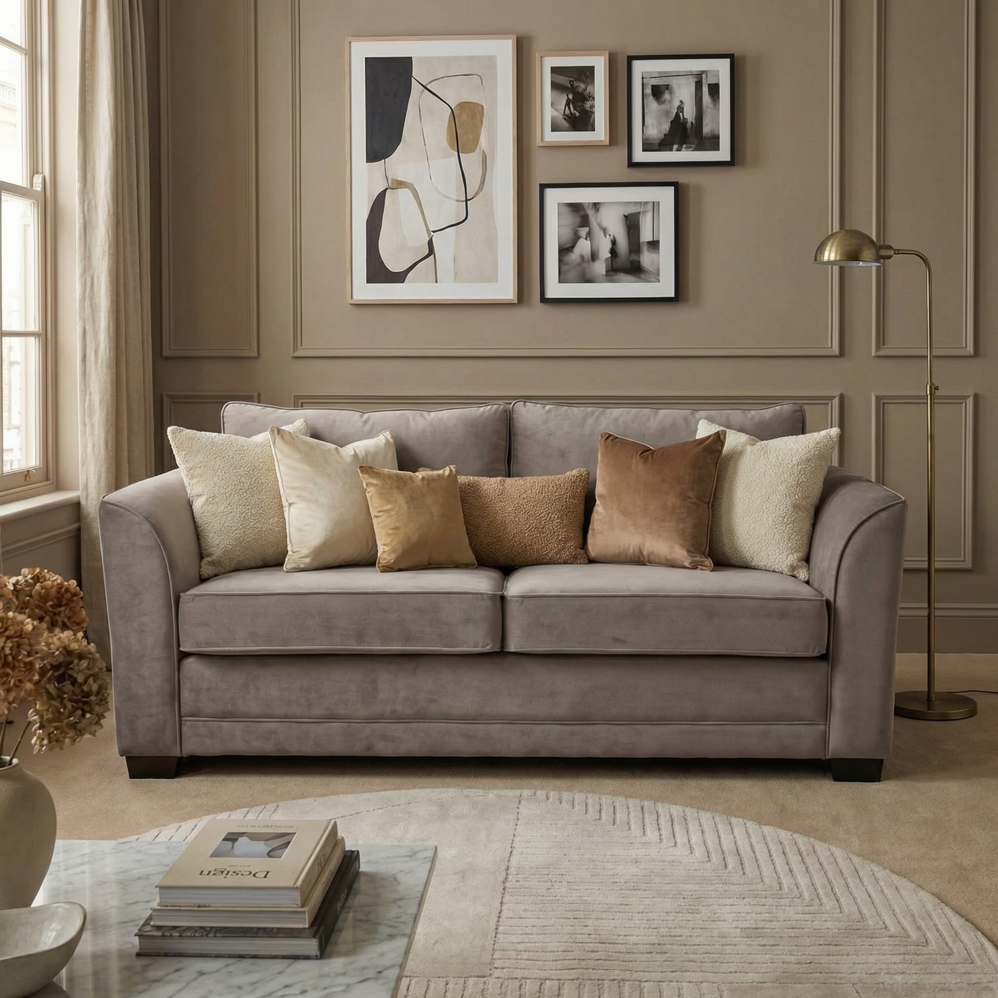 A mink Ardley 3 Seat Velvet Sofa Bed sits in a neutral-toned room with abstract art, offering stylish comfort.