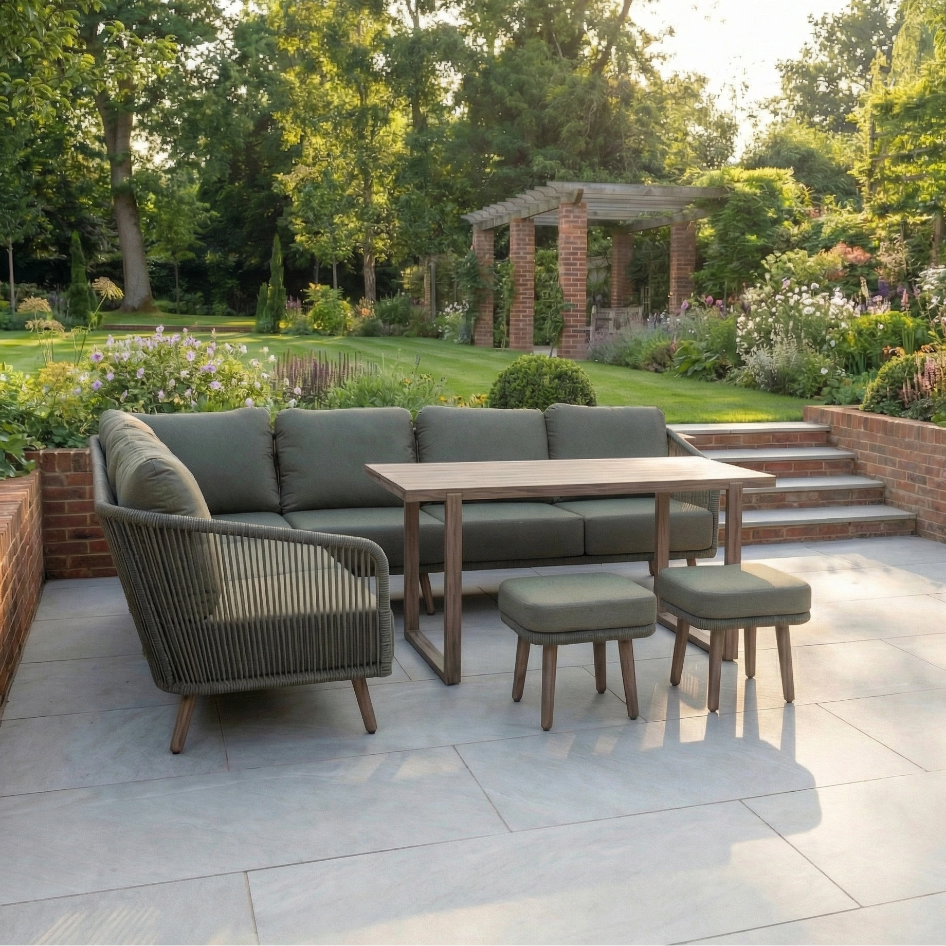 Outdoor patio with Ascot Corner Dining Set in Forest Green, featuring cushioned seating and a table, plus weather-resistant garden furniture, surrounded by flowers and a pergola in the background.