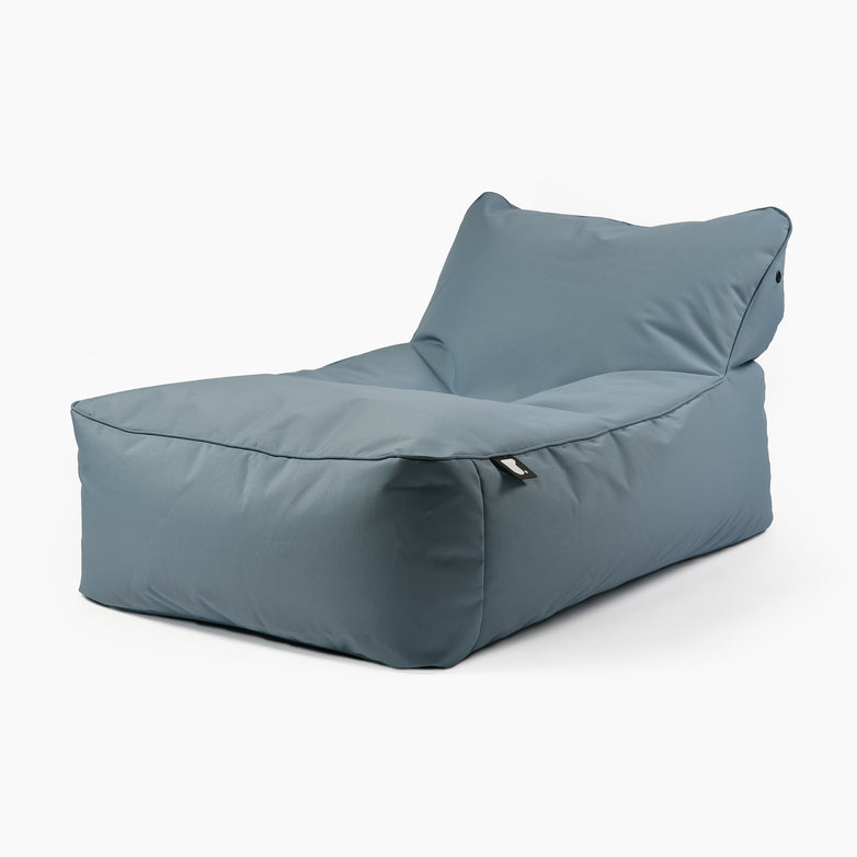 Introducing the Outdoor B-Bed in Sea Blue: a modern bean bag chair featuring a supportive backrest, designed for lounging in optimal comfort with its polybead filling.