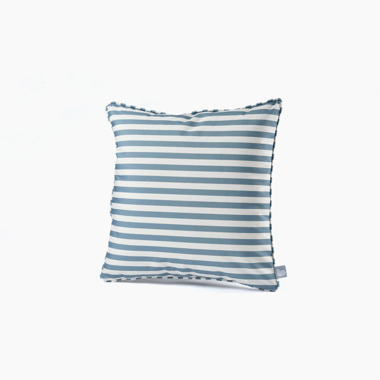 The Outdoor Pencil Stripe B-Cushion in Sea Blue features alternating blue and white horizontal stripes against a white background, made from splash-proof fabric.