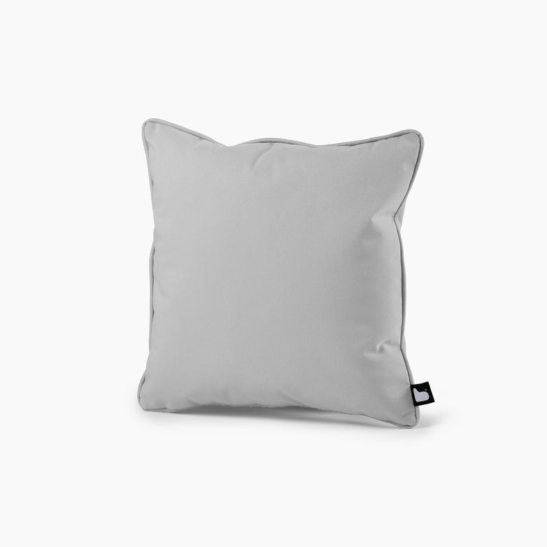 The Outdoor B-Cushion in Silver Grey, featuring a square shape and a small black tag on the lower right corner, stands out beautifully against a white background and is perfect for complementing your lounge furniture.