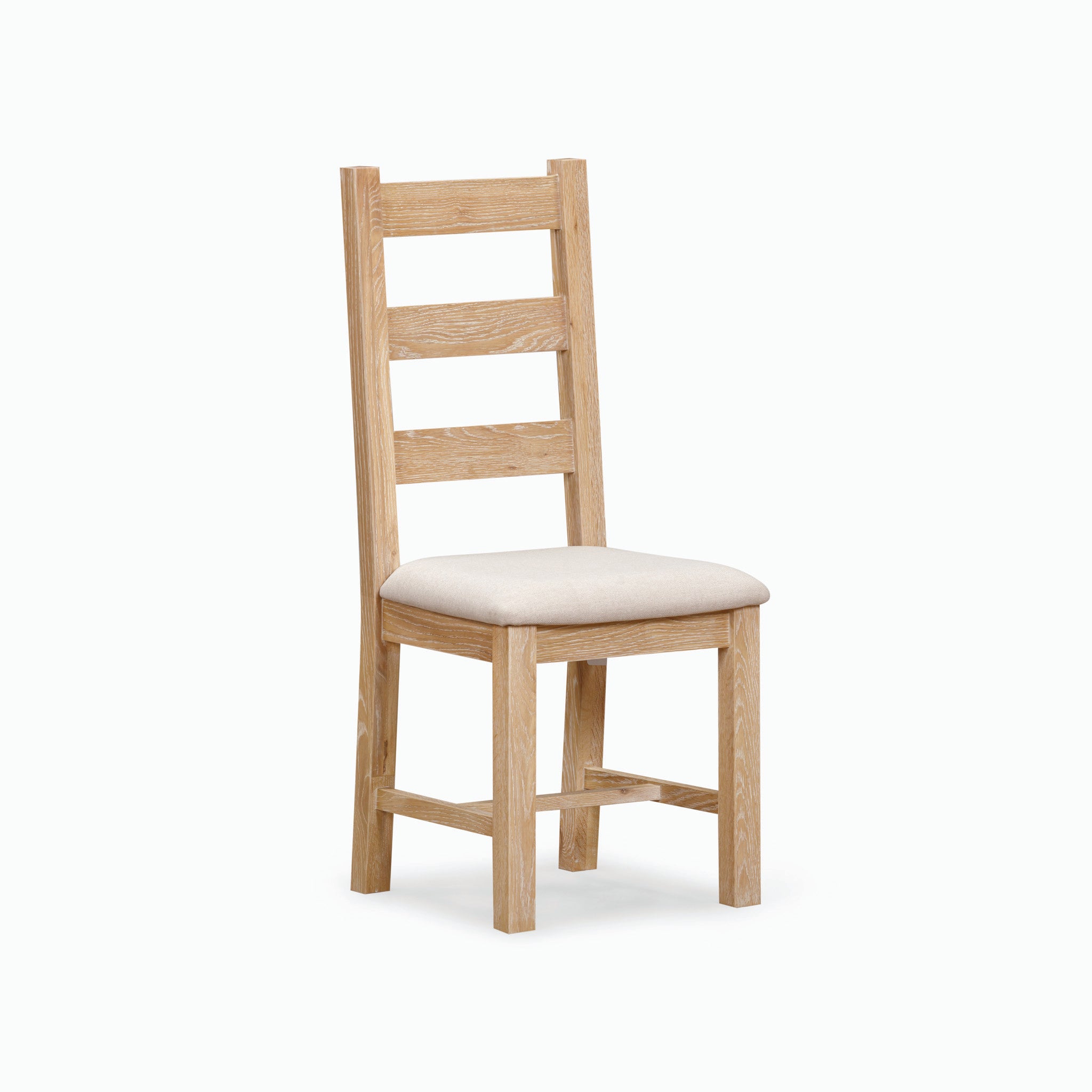 The Burford Set of 2 Ladderback Dining Chairs with Fabric Seat in Natural Oak is highlighted by a natural oak finish and a light-colored upholstered fabric seat, presented against a plain backdrop.