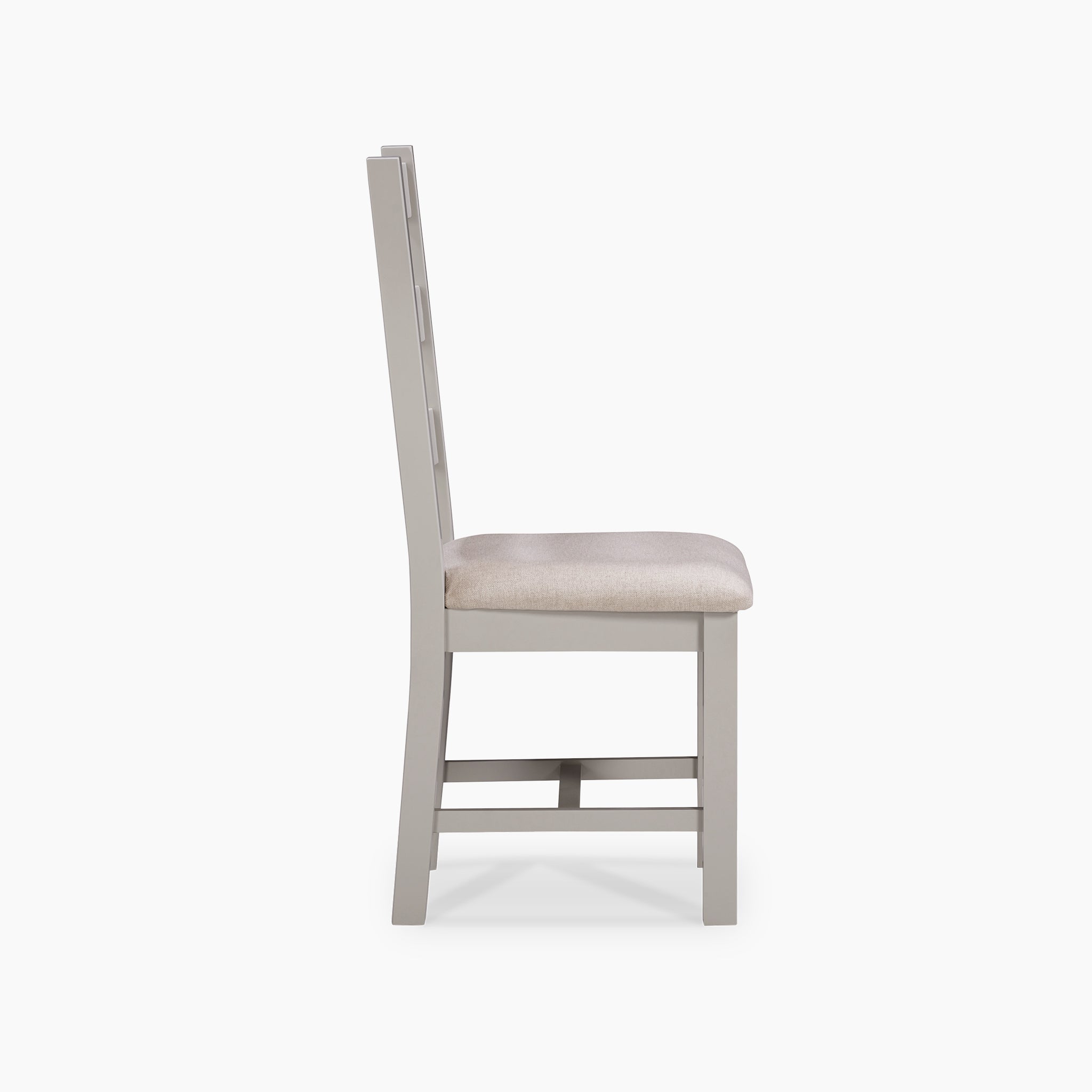 Side view of a Pebble Grey wooden chair with a beige cushioned seat, elegantly matching the Burford 6 Seat Extending Dining Set, set against a white background.