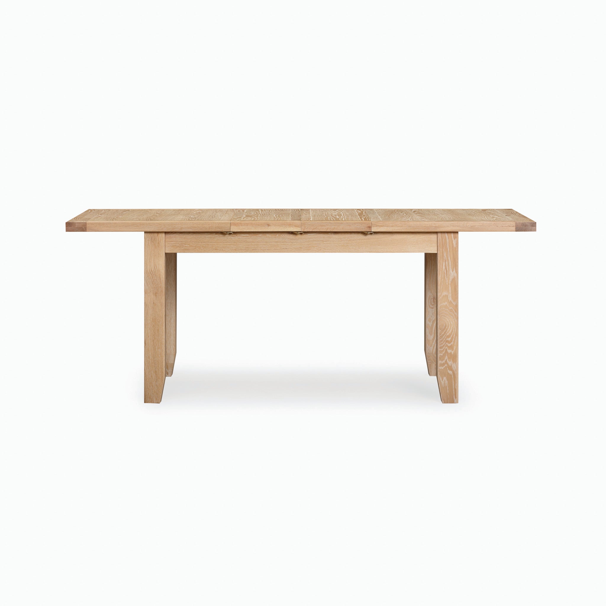 The Burford 6 Seat Extending Dining Set in Natural Oak features a rectangular top with sturdy legs, all beautifully finished in a subtle whitewash, set against a plain white background.