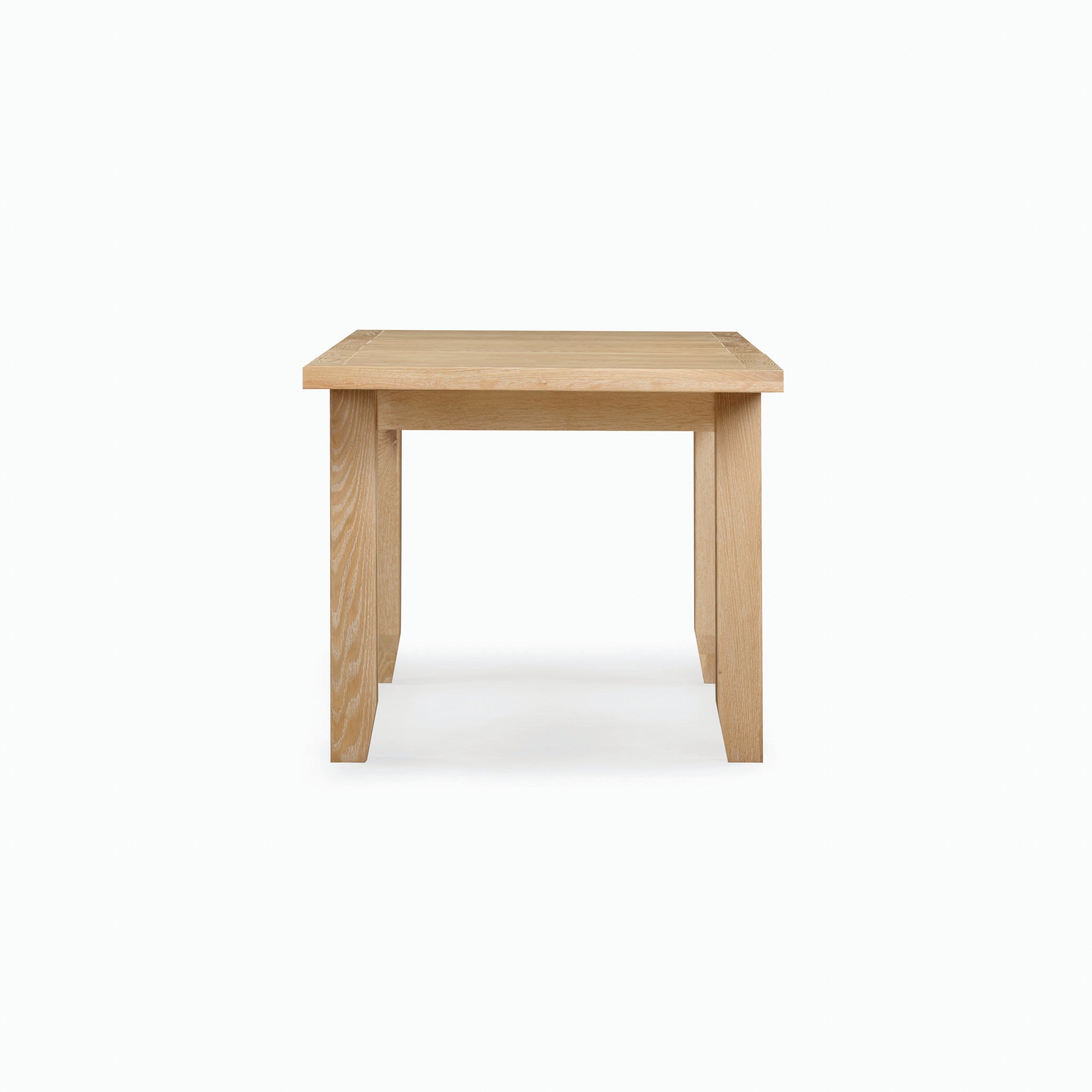 The Burford 6 Seat Extending Dining Set in Natural Oak showcases a wooden table, viewed from the front against a simple white backdrop.