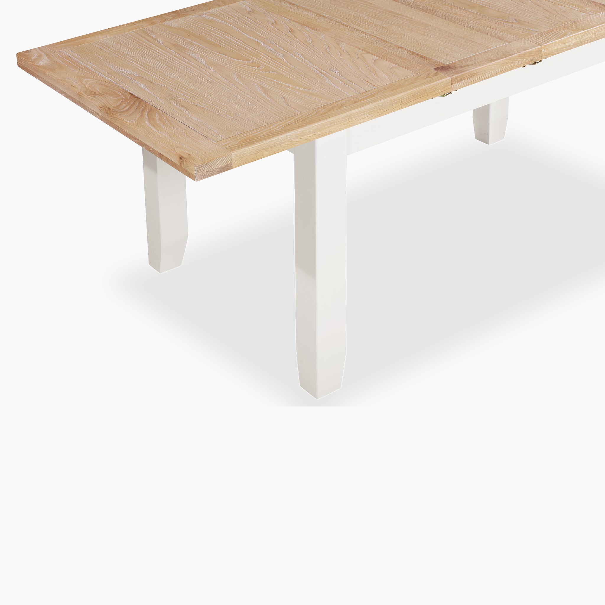 Burford 6 Seat Extending Dining Set with Spindleback Dining Chair in Warm White, light wood and white legs, shown from an angled side view against a white background.