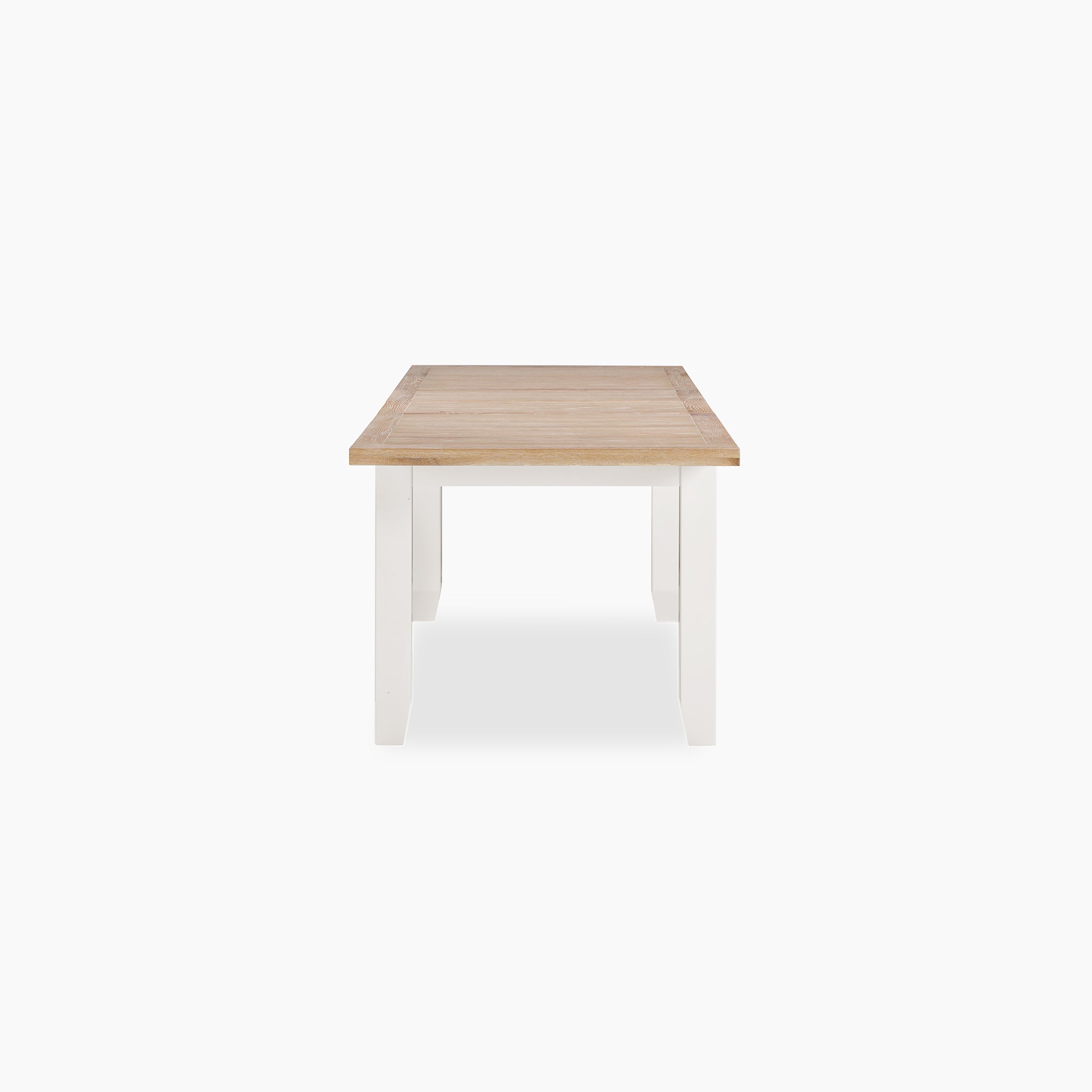 The Burford 8 Seat Extending Dining Set features a solid oak dining table with a light brown top and white legs, paired with matching spindleback chairs in warm white—ideal for stylish, spacious dining.