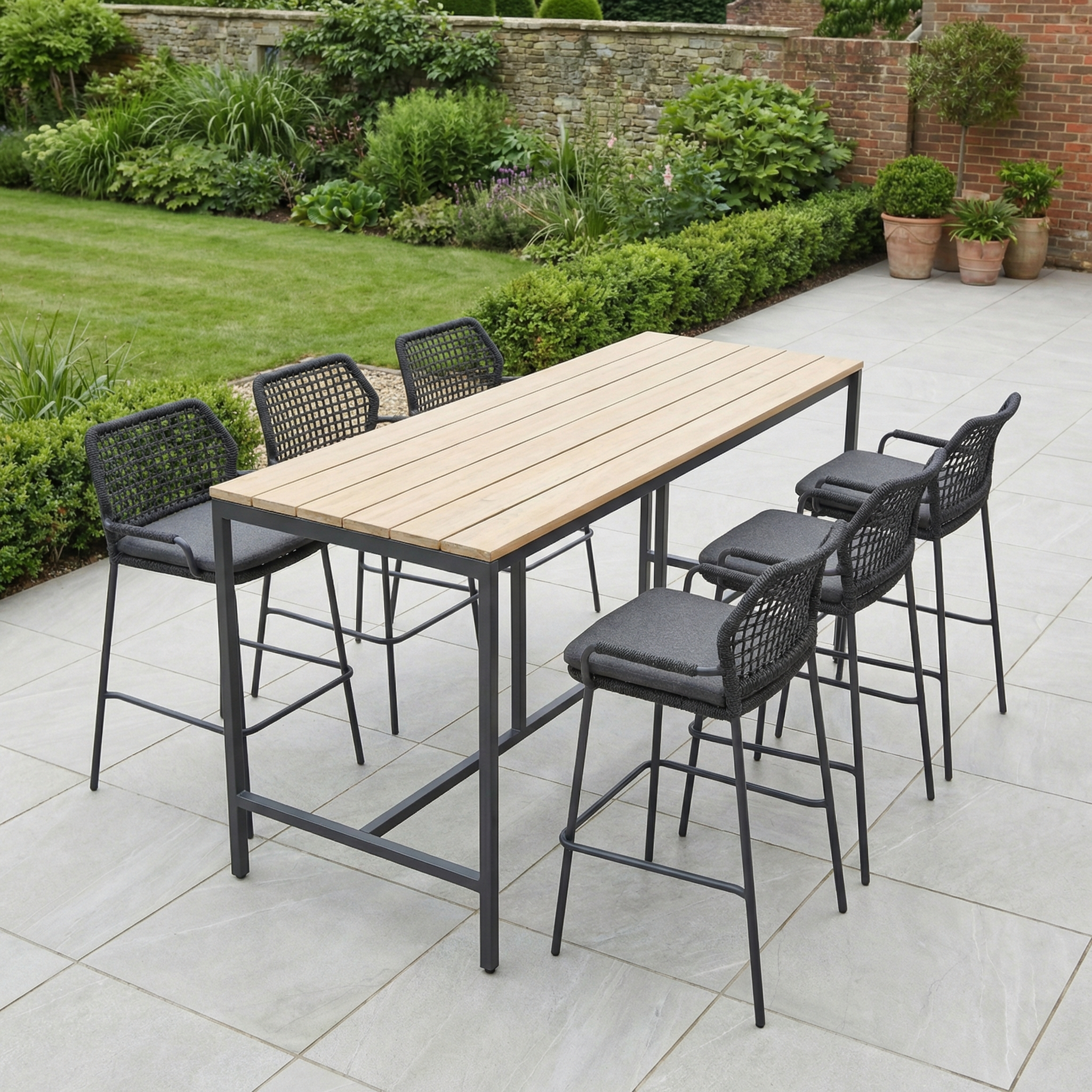 The Barista 6 Seat Bar Set with Teak Table in Anthracite features six bar chairs and a stylish teak table, perfect for adding modern flair to your patio or garden.