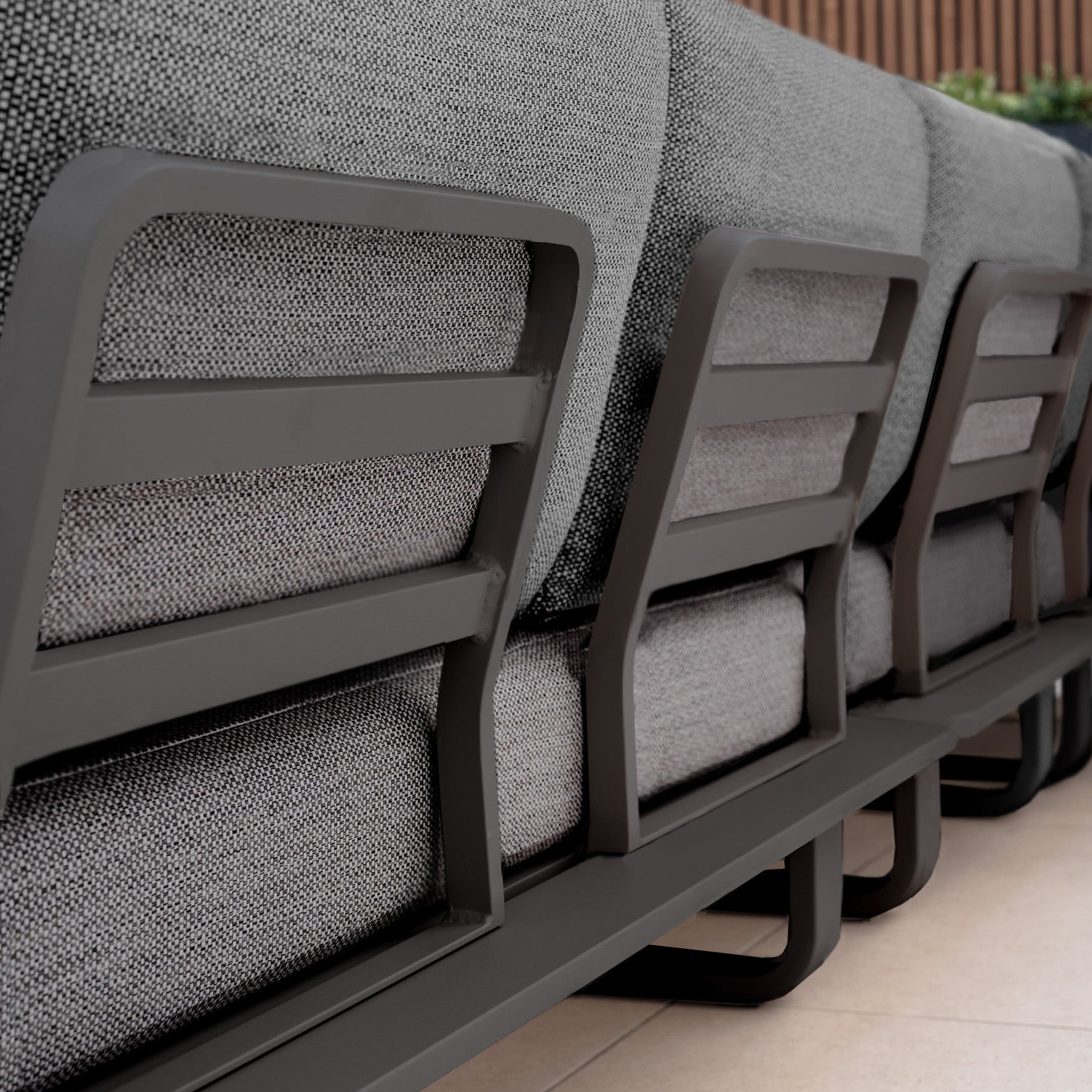 Close-up of the back of a modern Bay Large Corner Group Set with Aluminium Frame in Charcoal, featuring a powder coated aluminium frame and durable Olefin material.