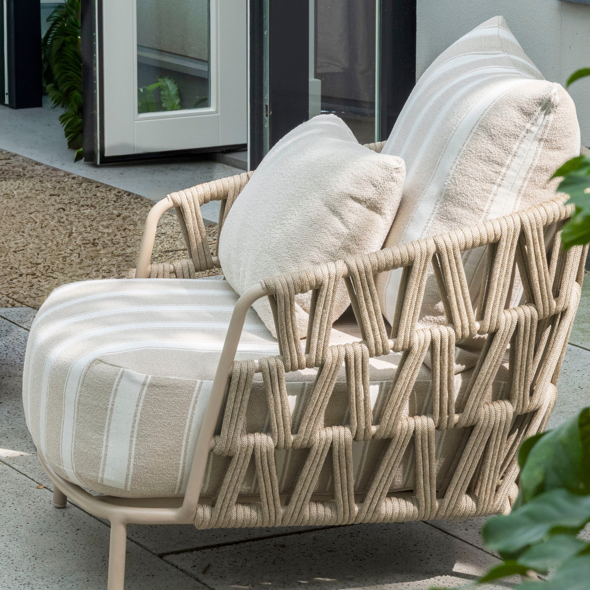 Beige outdoor lounge chair with striped cushions and woven rope design, pairs perfectly with the Madeira 3 Seat Sofa Set in Striped Latte for a stylish patio near the door.