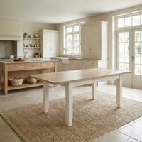 Bright, airy kitchen featuring the Burford 4-6 Seater Extending Dining Table in Warm White, wooden cabinets, open shelving, and large windows that flood the space with natural light.