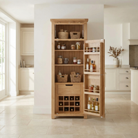 The Burford Single Larder Unit in Natural Oak is shown with open doors, displaying neatly organized jars, baskets, and bottles for stylish kitchen storage.