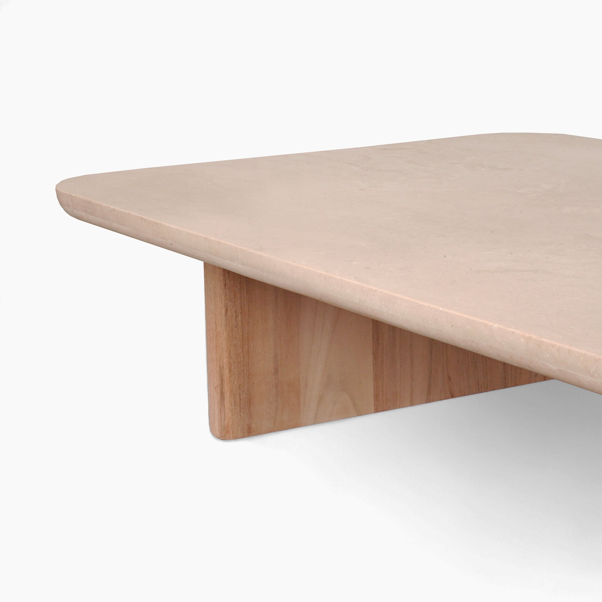 A close-up of the Tivoli Large Corner Set's smooth-edged, beige marble coffee table in fawn, featuring a rectangular design supported by a teak wood leg.