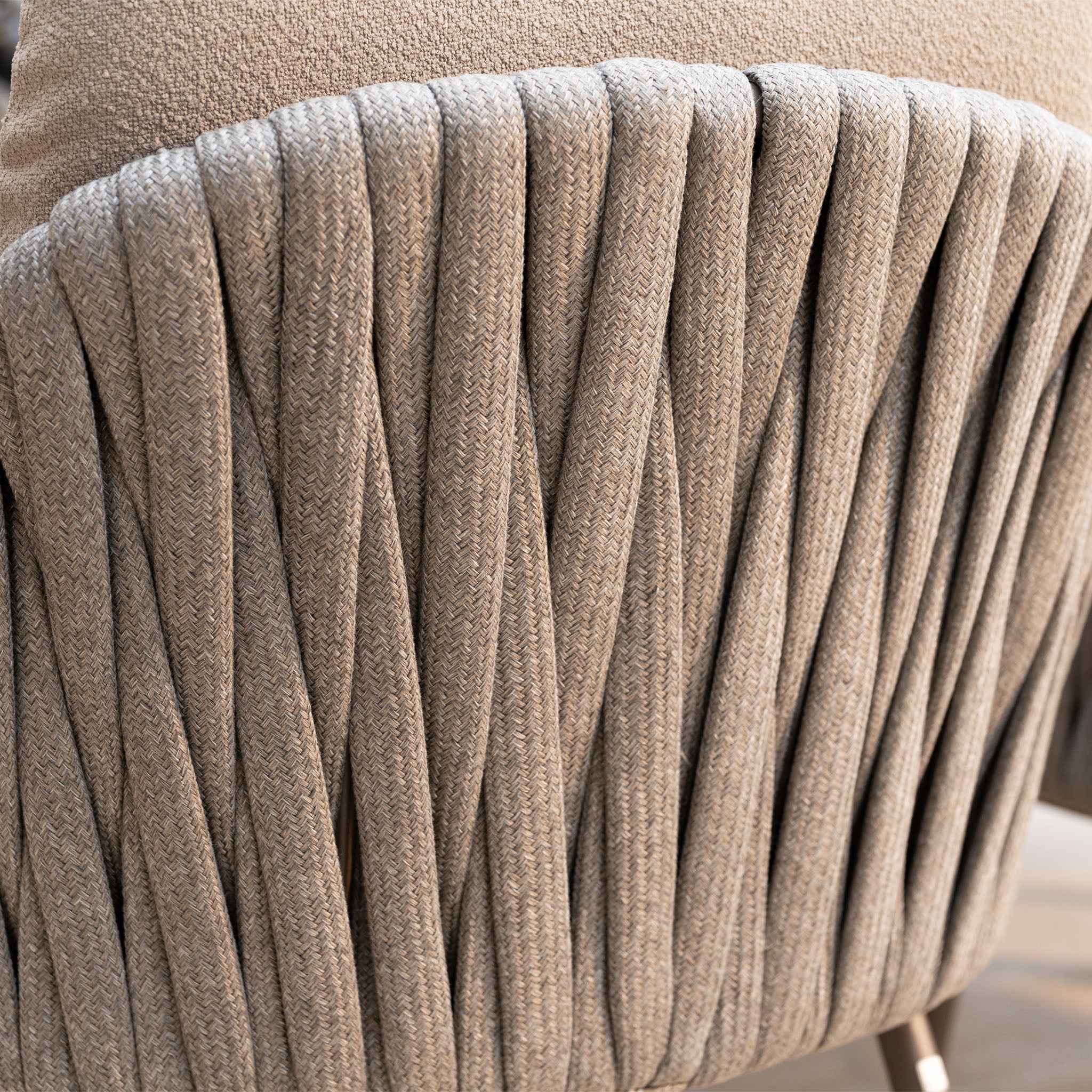 Close-up of a textured beige fabric chair with twisted woven backrest—perfectly complementing the Capri 3 Seat Sofa Set in Stone Grey for elegant garden furniture.