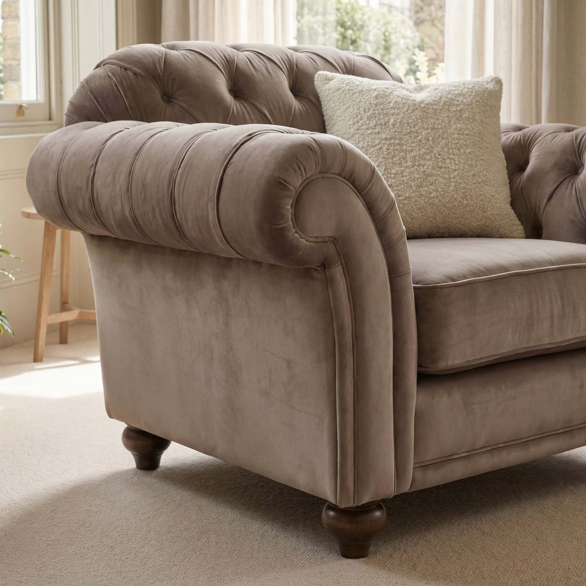 Chesterfield Velvet Armchair in Mink with a light textured cushion is featured in a sunlit living room.