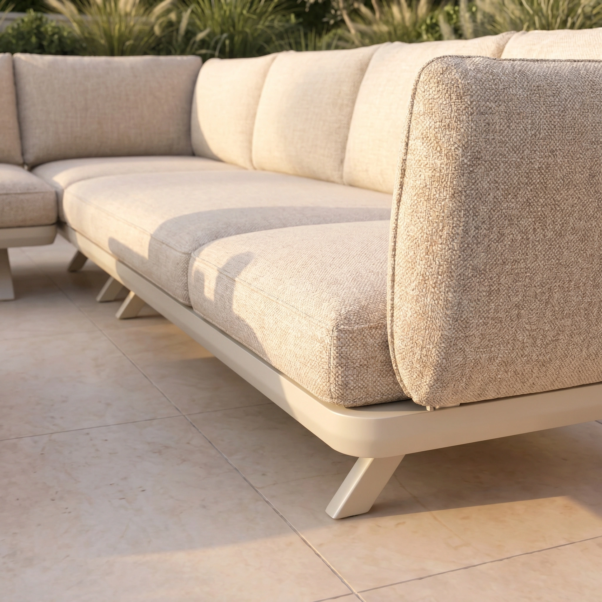 Como U-Shape Corner Sofa Set with Altura Rising Table in Oatmeal, featuring plush cushions, is arranged on a tiled patio with greenery in the background.
