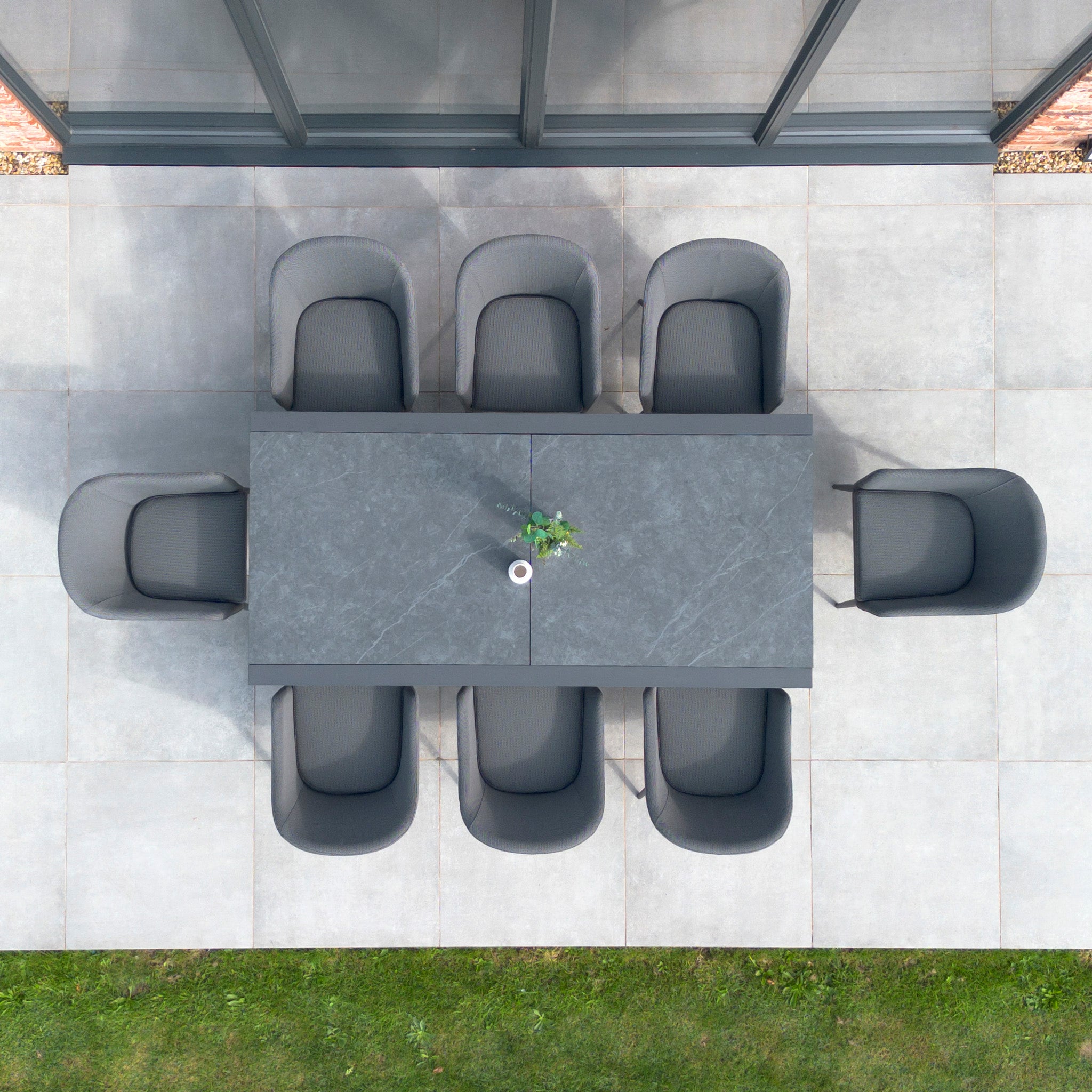 Top view of the Luna 8 Seat Outdoor Fabric Extending Ceramic Dining Set in Grey, featuring a rust-proof rectangular table with eight chairs, set for one.