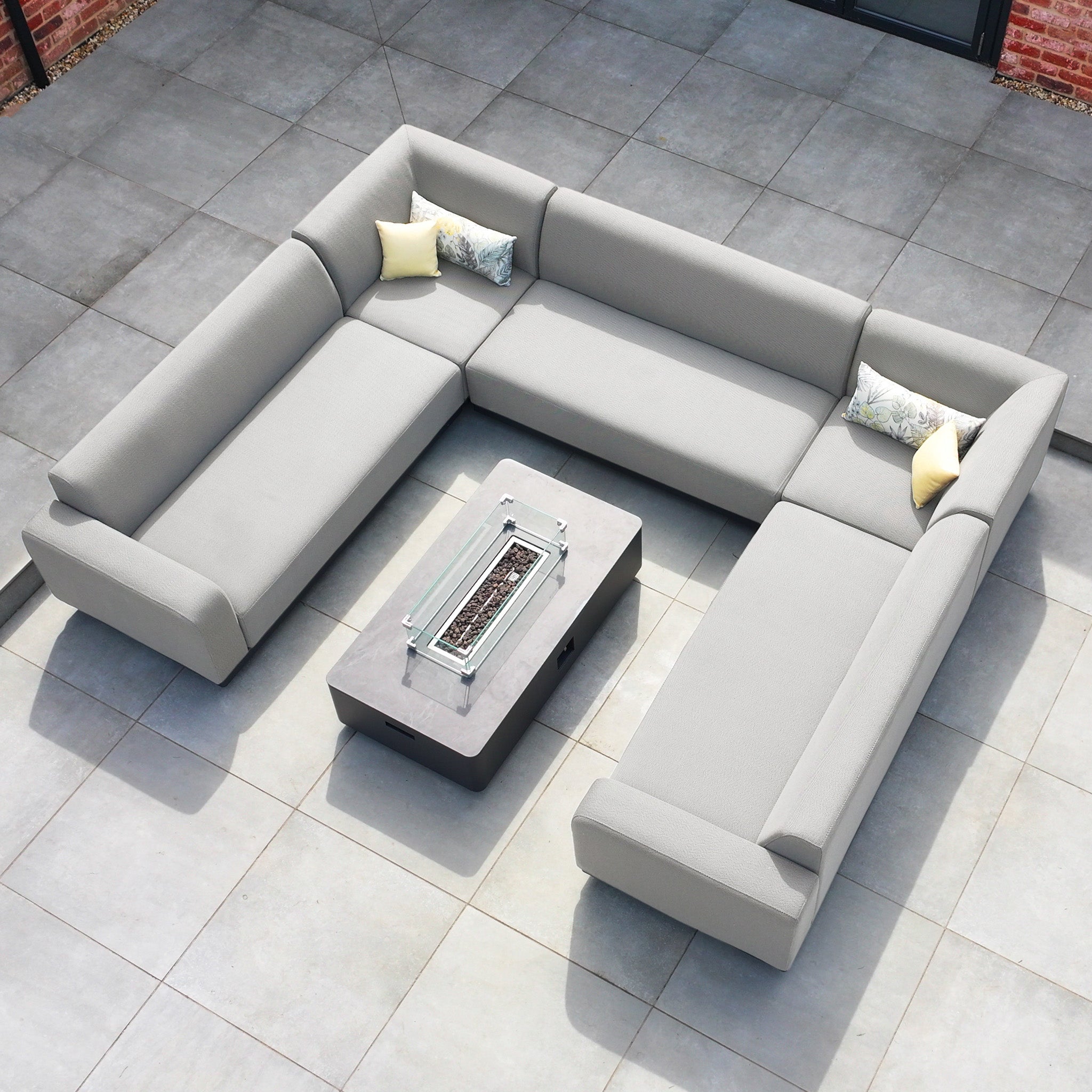 The Luna U-Shape Outdoor Fabric Sofa Set with Firepit Coffee Table in Oyster Grey offers all-weather proof comfort and style, featuring plush cushions and a modern design perfect for any tiled patio.