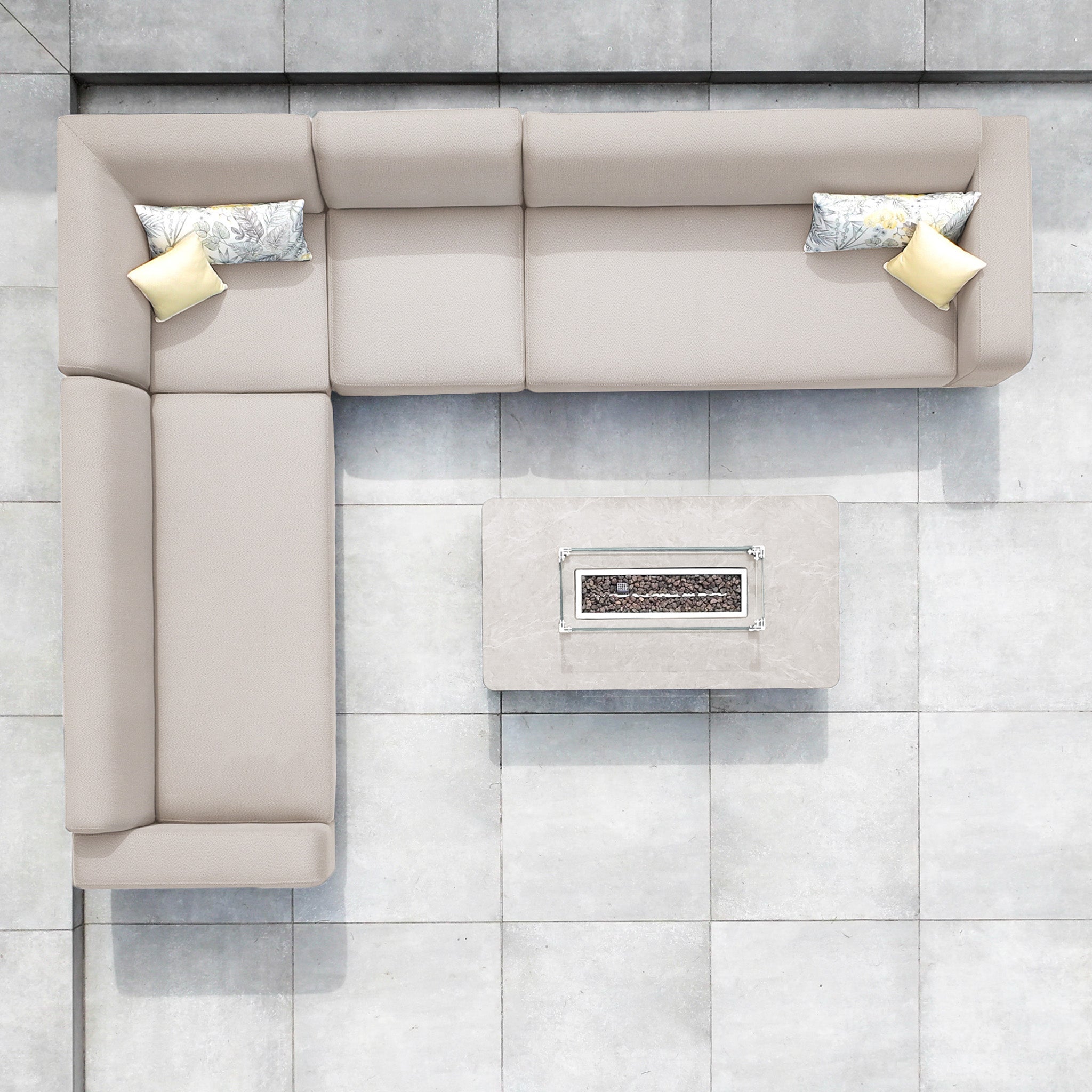 Top view of the Luna Outdoor Fabric Corner Sofa Set with Firepit Coffee Table in Fawn, featuring pillows and placed on tiled flooring.