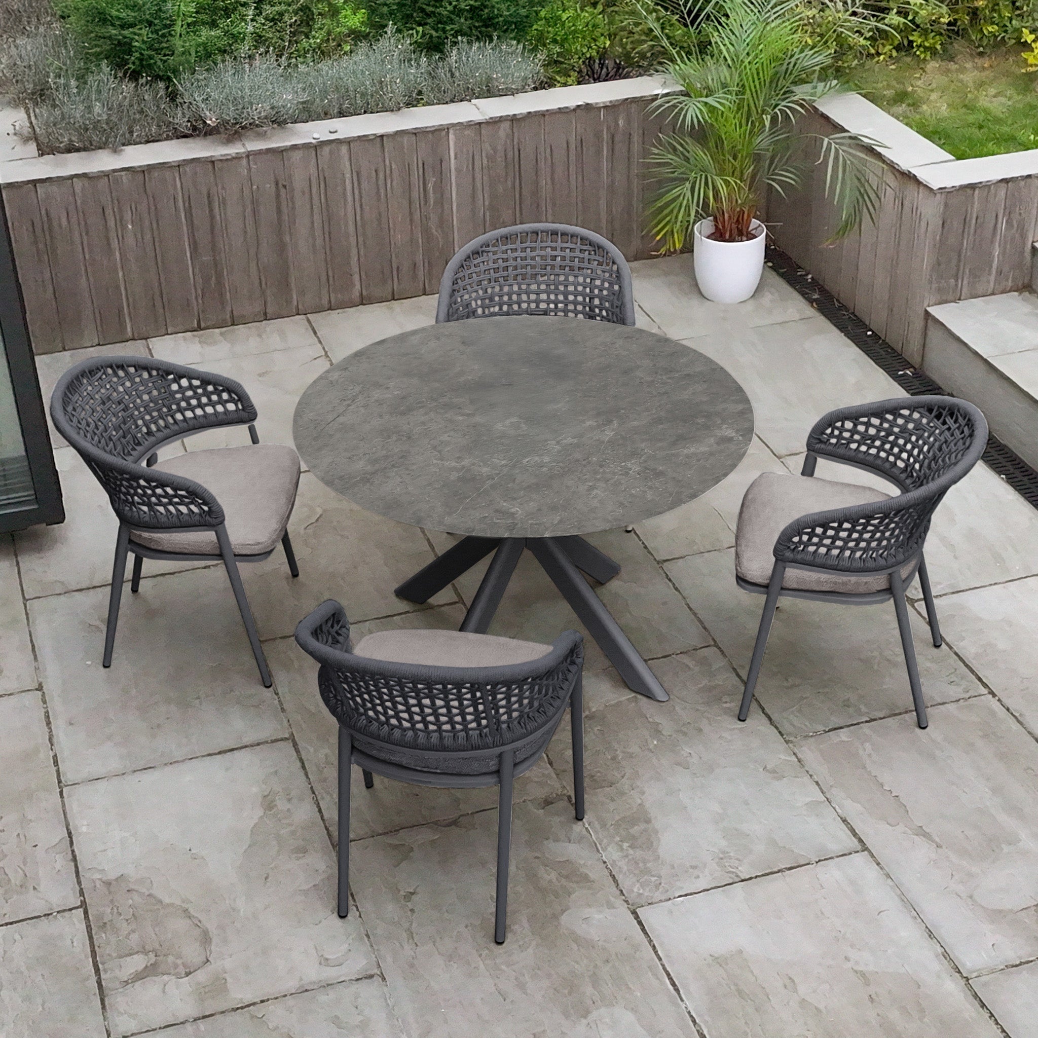 Enjoy outdoor meals with the Kalama 4 Seat Round Rope Dining Set with Albatross Table in Truffle, featuring a stylish round table and four chairs. Ideal for relaxing gatherings and enhancing your outdoor dining experience.