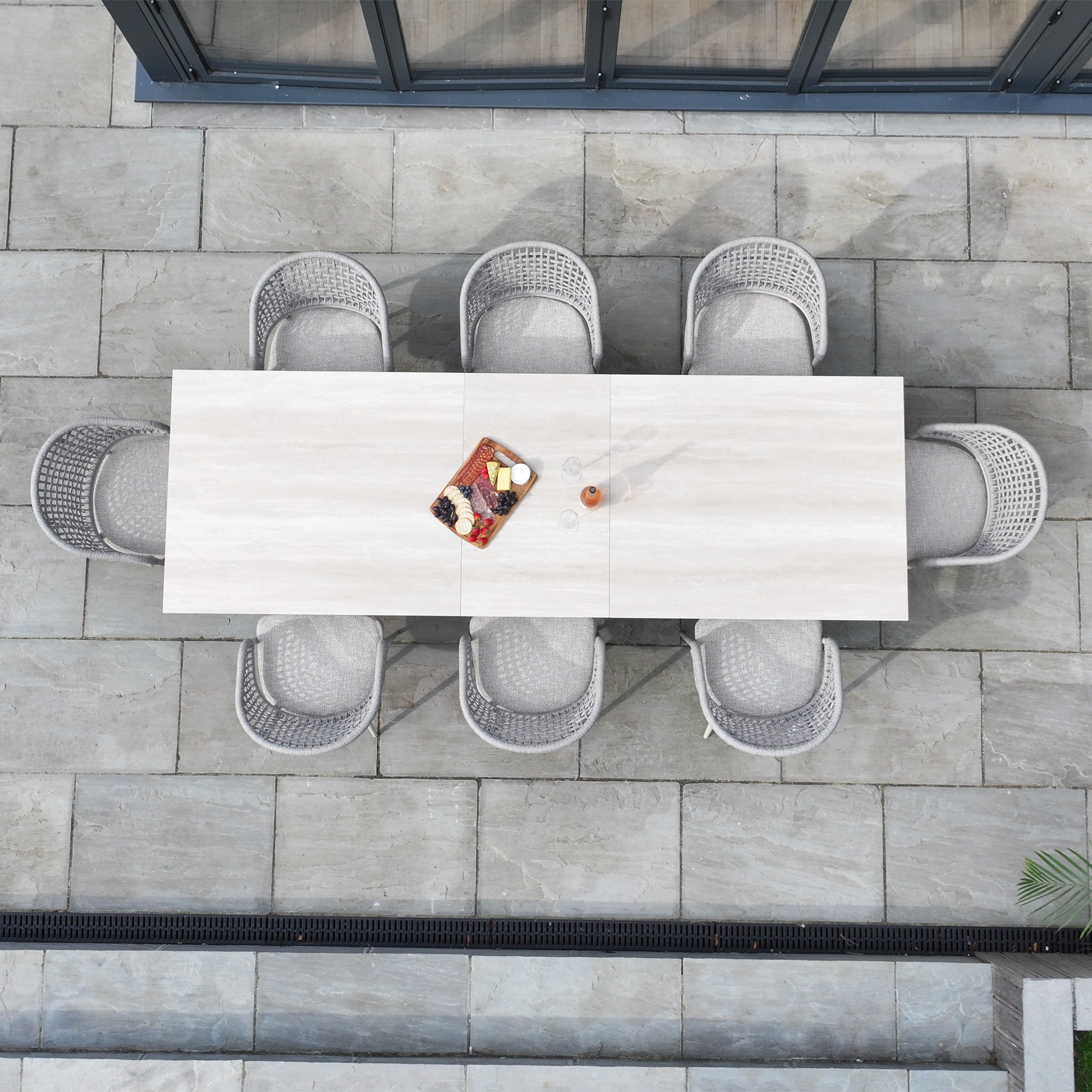 The Kalama 8 Seat Rope Dining Set with Albatross Extending Table in Oatmeal offers elegant outdoor dining with a spacious, extendable table and eight stylish chairs—ideal for relaxing or entertaining in style.