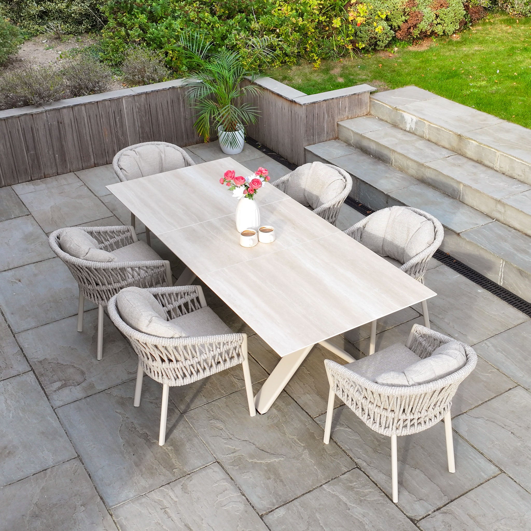 Enhance your patio with the Pello 6 Seat Dining Set with Albatross Extending Table in Fawn, featuring six cushioned chairs—an elegant addition to any outdoor dining furniture collection.