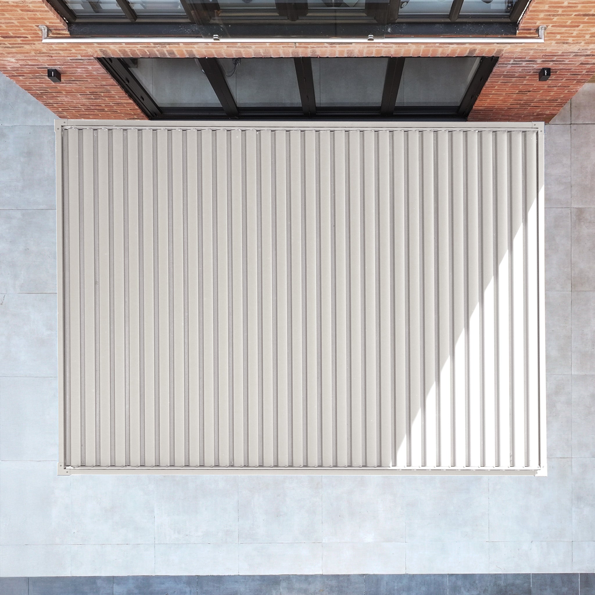 Aerial view of the PergoSTET Plus 3m x 4m Rectangular Pergola in Latte, featuring a waterproof metal roof, 3 drop sides, and LED lighting—ideal for modern spaces and includes full assembly instructions.
