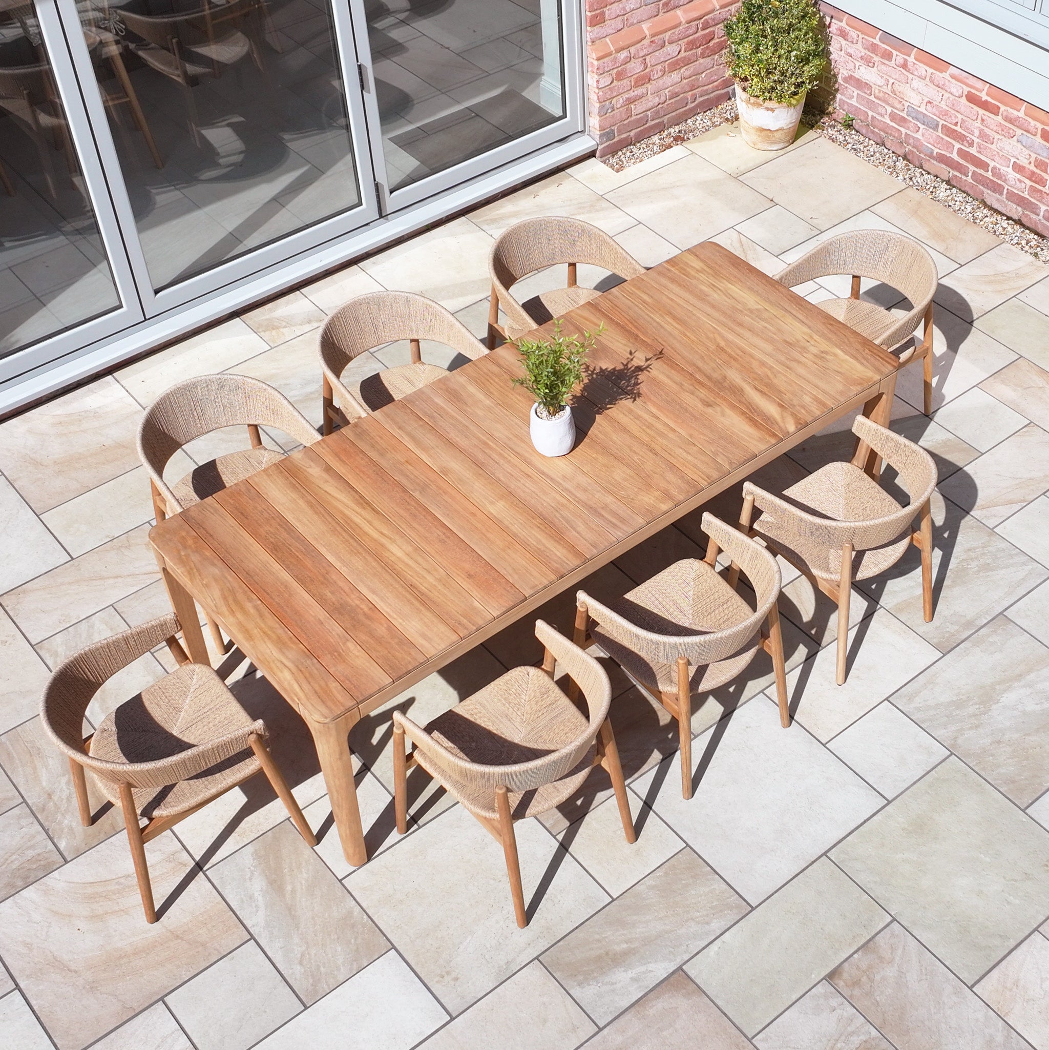 The Lucca 8 Seat Dining Set with Teak Table in Natural Weave offers spacious seating and elegant style, making it perfect for outdoor patio gatherings.
