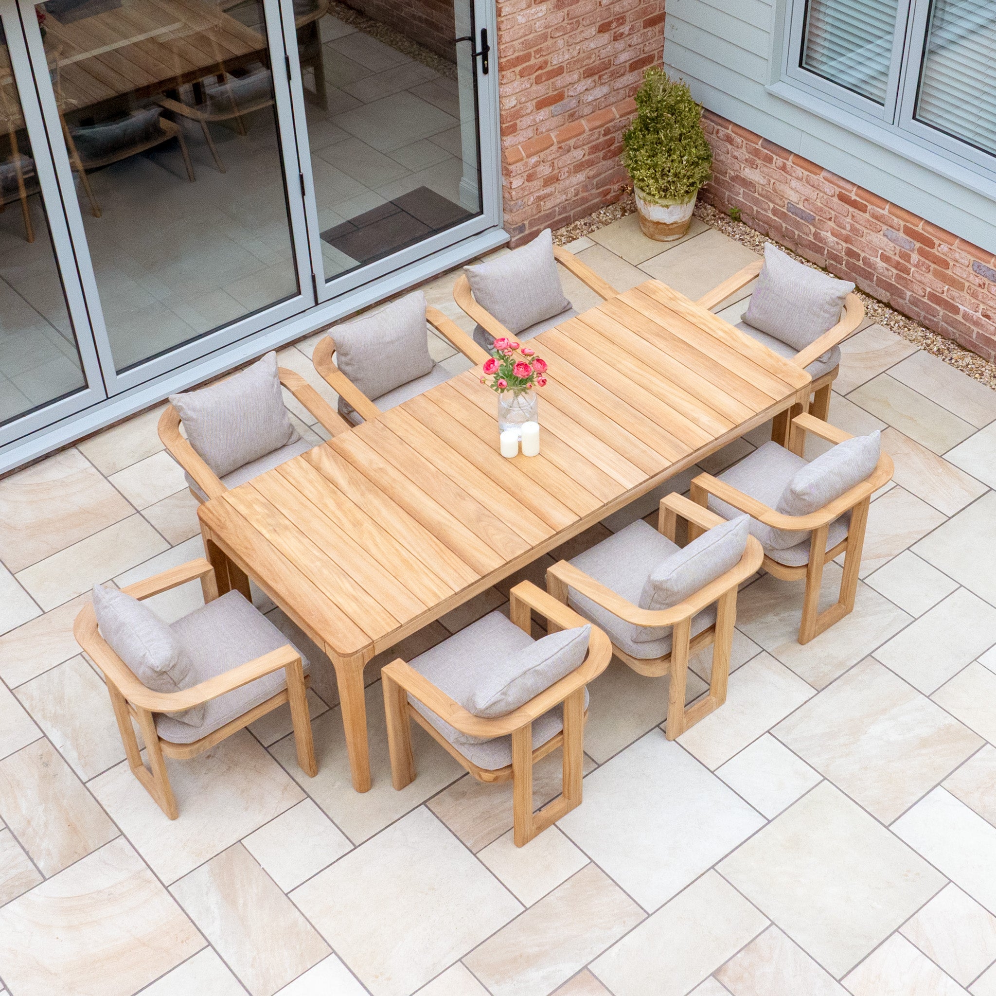 The Tivoli 8 Seat Dining Set with Teak Dining Table in Fawn includes eight cushioned chairs, making it perfect for stylish and comfortable outdoor gatherings on your patio.