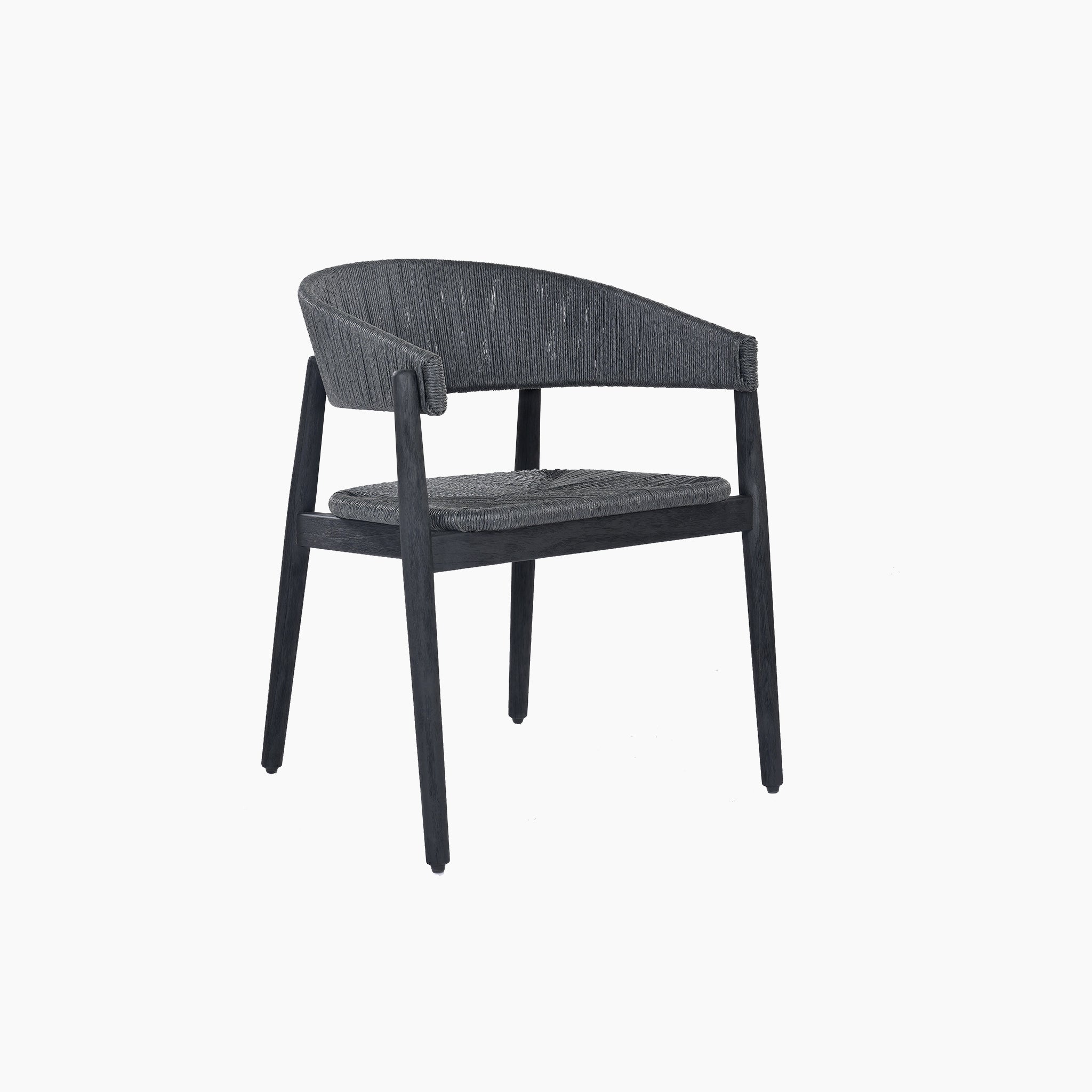The Lucca 6 Seat Dining Set features a round teak table and minimalist black wooden chairs with curved backrests and hand-woven wicker seats, making it perfect for enhancing your outdoor dining area.