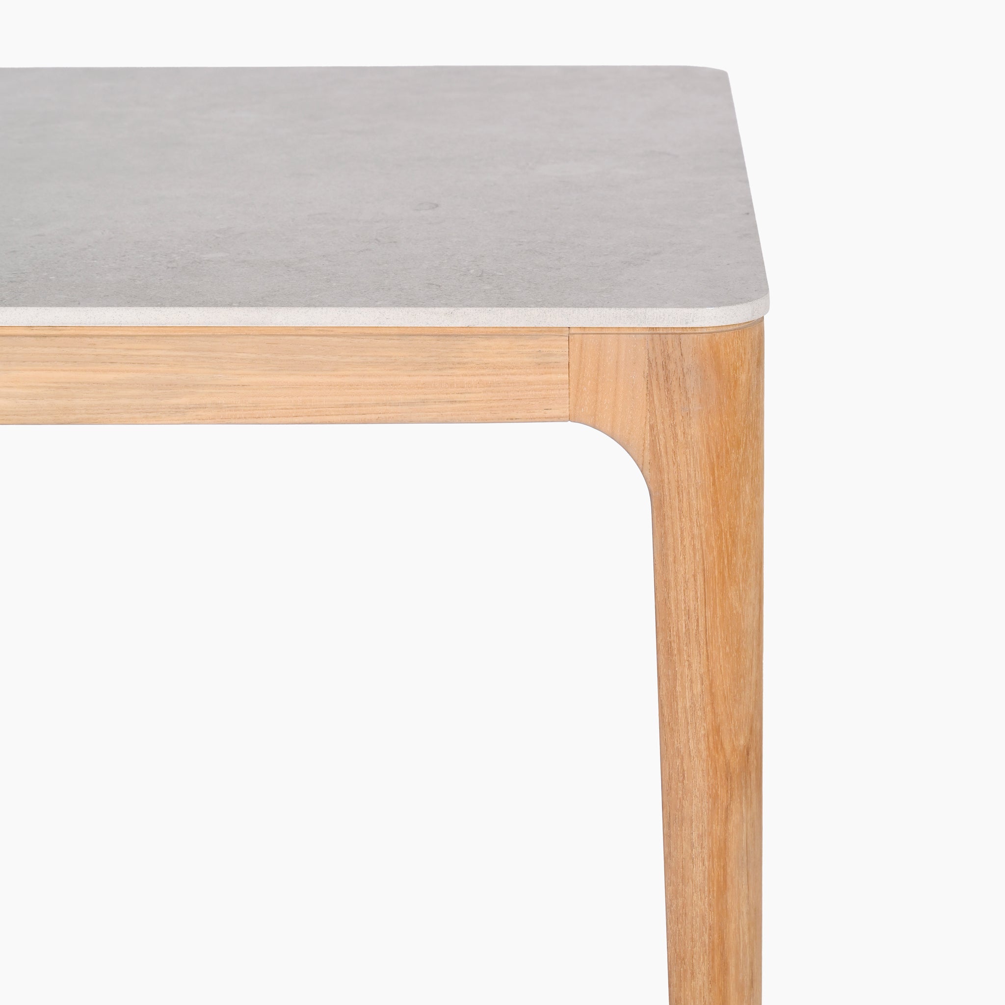 The elegant Sora 8 Seat Rope Dining Set features a ceramic top table in stone with teak frames and smooth, light gray surfaces, complemented by curved edges for style and function.