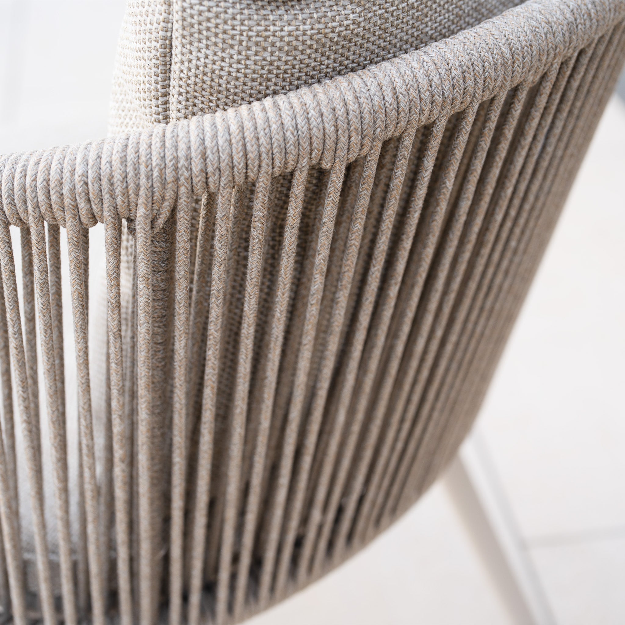 Close-up of the Dekota Dining Chair in Fawn, featuring a woven fabric backrest and light wood legs. (Set of 2).