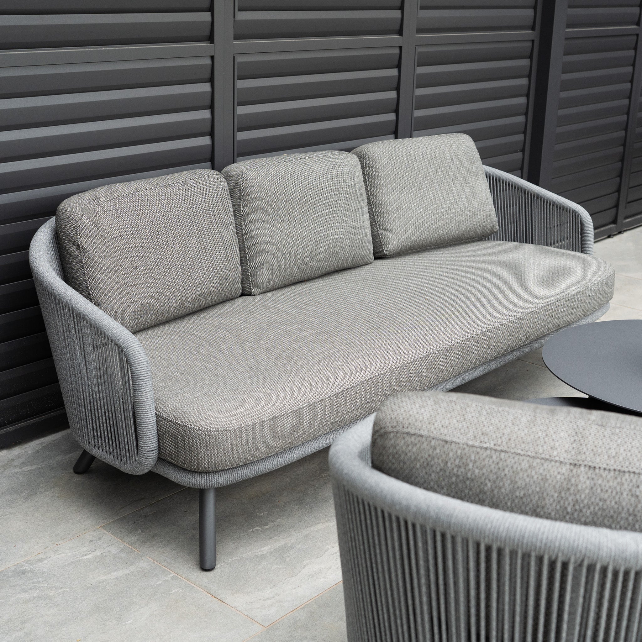Dekota 3 Seat Rope Sofa Set in Charcoal, with coffee tables and footstool, offers outdoor luxury with its modern design—perfect for relaxing on your patio.
