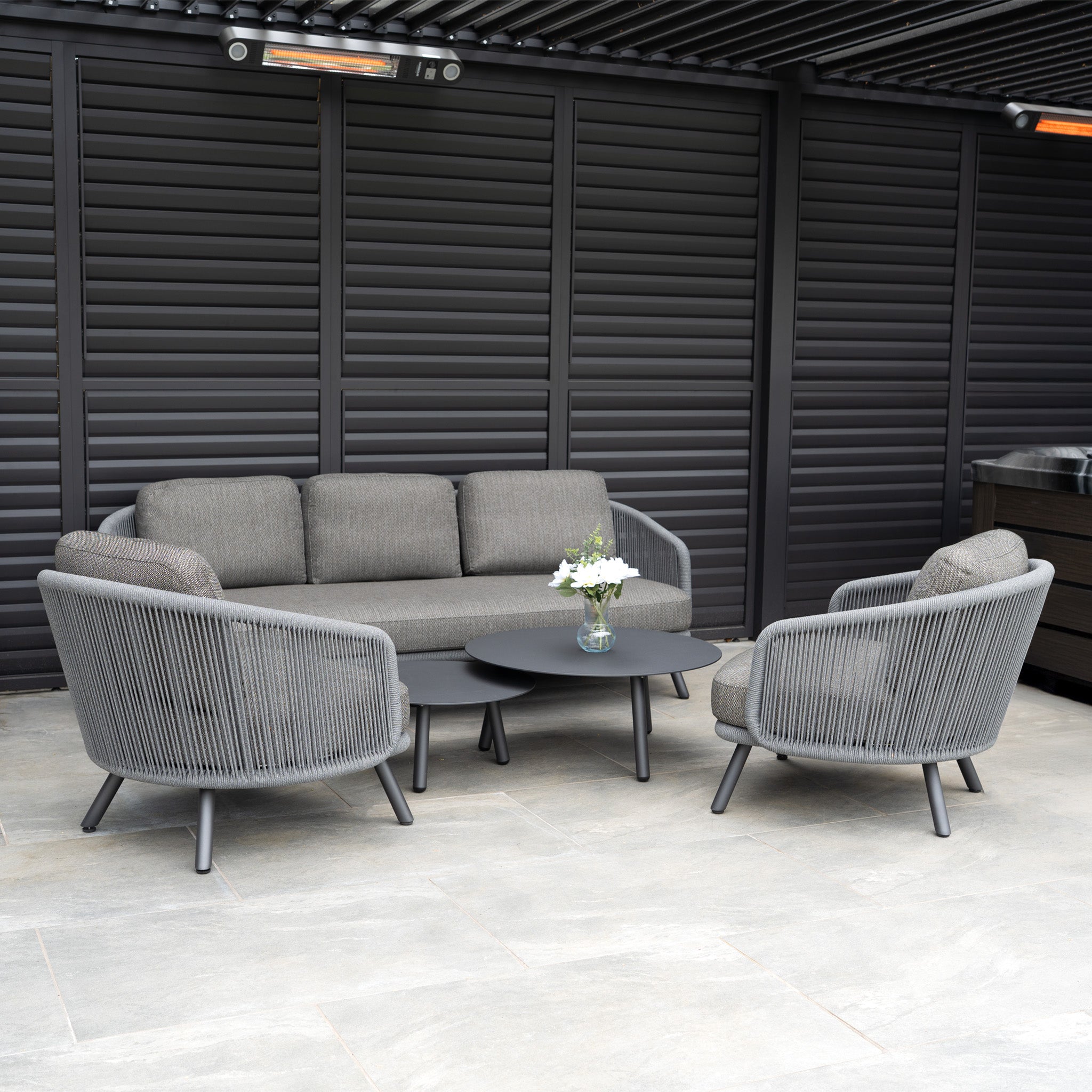 Elevate your patio with the Dekota 3 Seat Rope Sofa Set in Charcoal, complete with coffee tables and a footstool—an elegant choice for stylish outdoor relaxation.