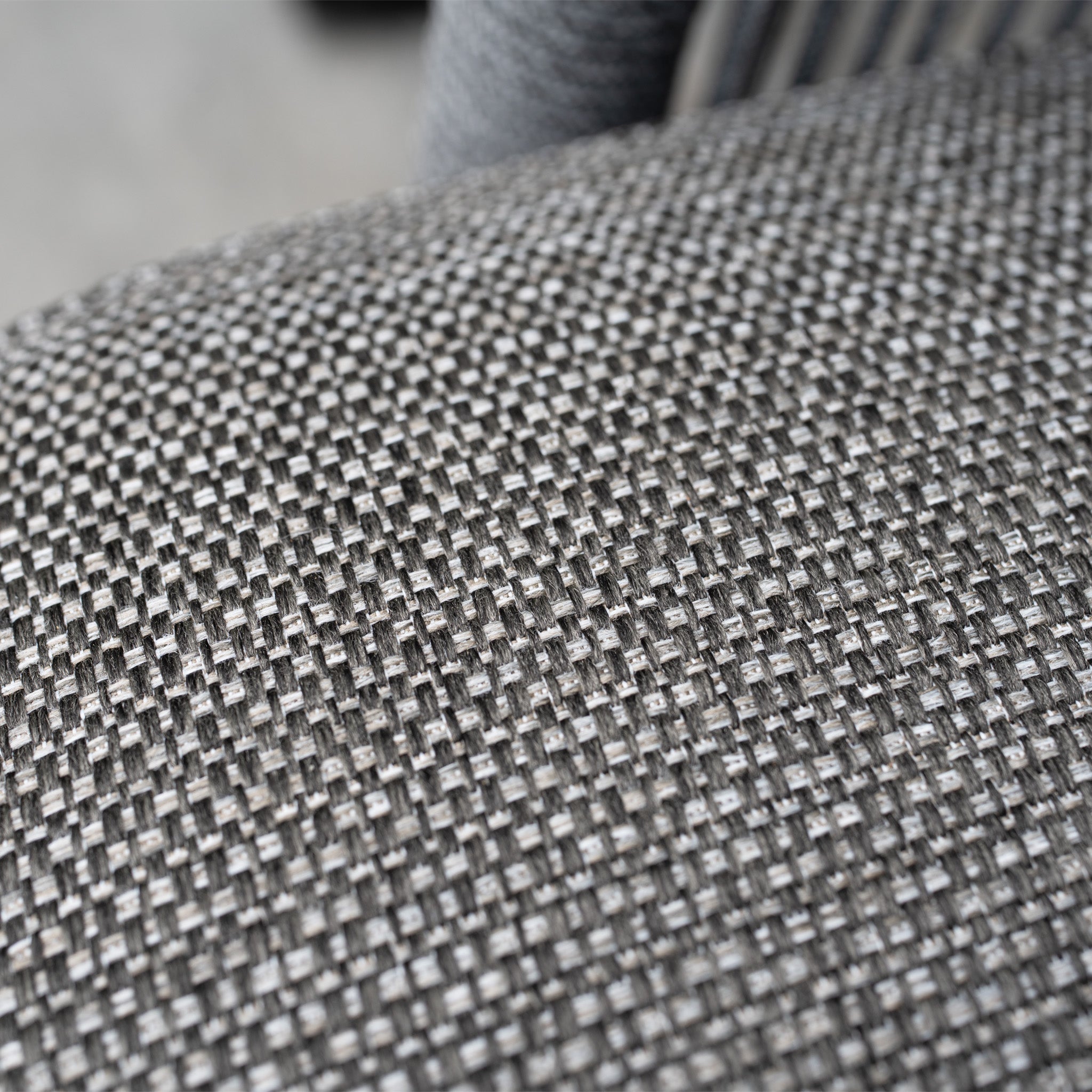 Close-up of gray woven olefin fabric with a textured, interlaced pattern, featured on the Dekota 3 Seat Rope Sofa Set with Coffee Tables and Footstool in Charcoal for outdoor luxury.